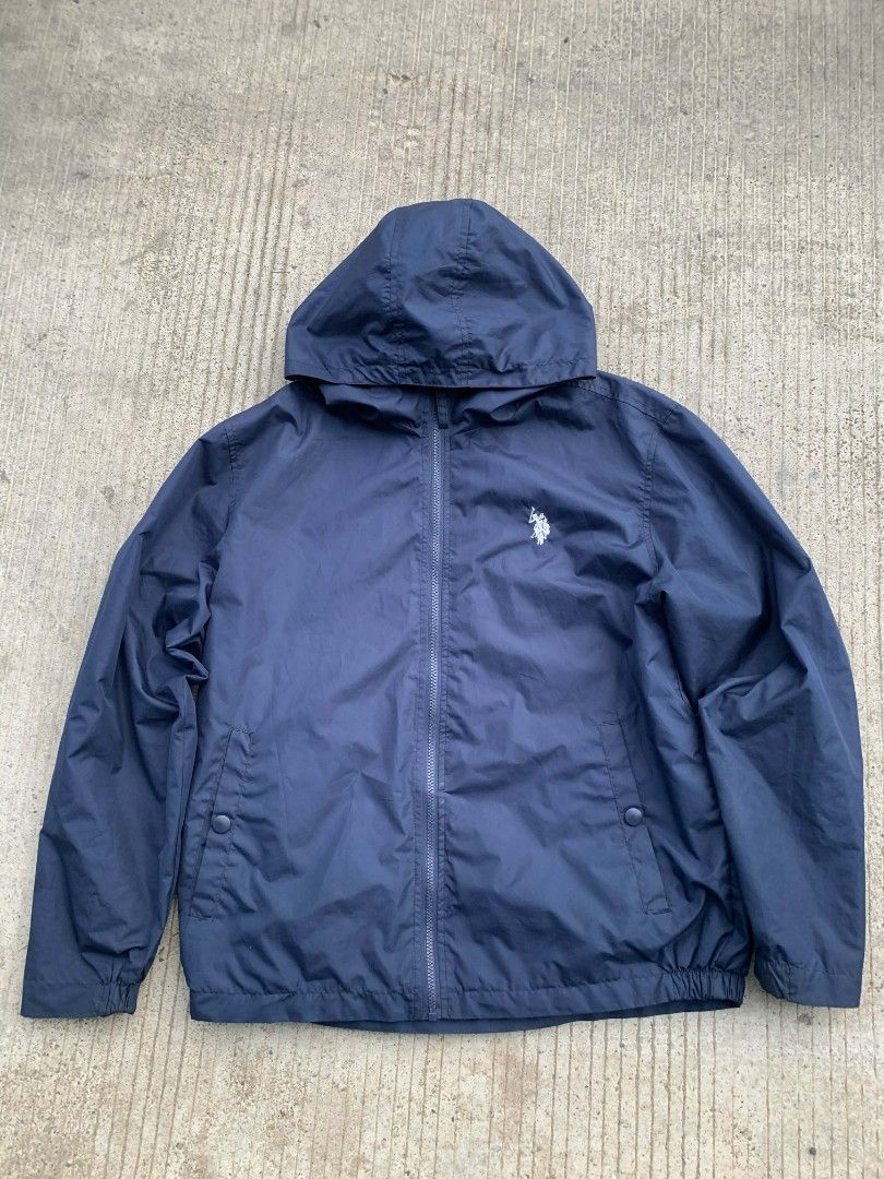 Wind breaker US Polo Assn. Navy Blue Jacket (Category: Coats, Jackets and Outerwear) located in San Jose. Submitted by thriftsja (Listing ID 1418308296, Image 1). Description: Navy blue jacket from US Polo Assn. Features a hood and a full-length zipper. Includes the brand's logo on the chest. The jacket has two side pockets and elastic cuffs. Perfect for casual wear..