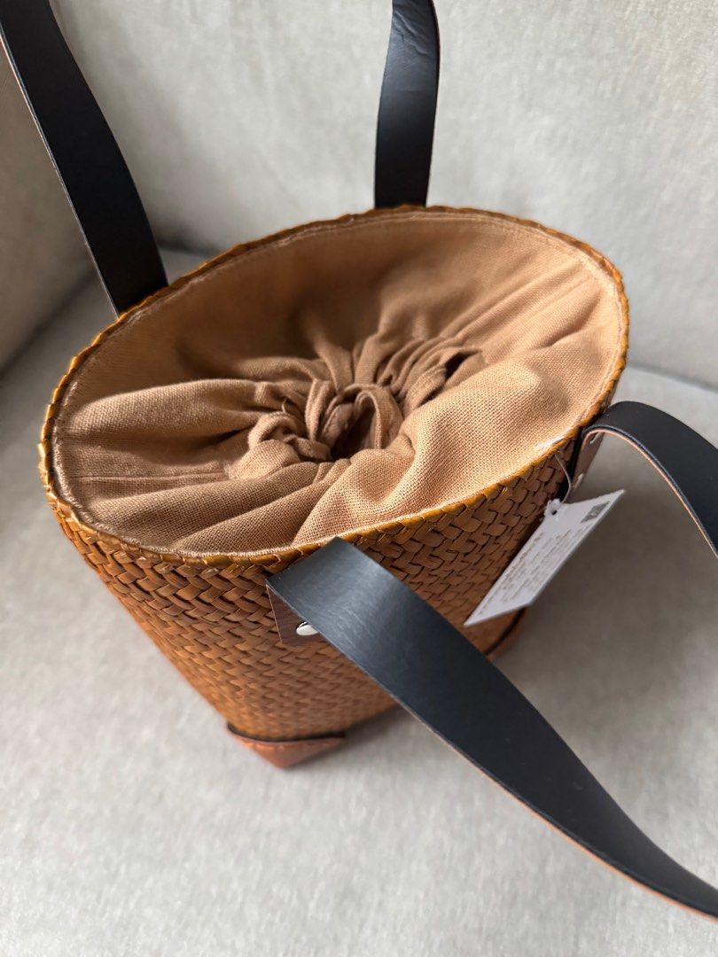 Woven Basket Bag with Leather Handles (Category: Tote Bags) located in Quezon City. Submitted by smt00 (Listing ID 1418227346, Image 3). Description: - Woven bucket bag - Brown leather handles and accents - Leather corner details - Made of natural woven material - Width: 6.5in Height: 7in - Bought in Bangkok .