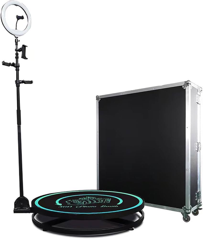 360 Photo Booth with Ring Light (Category: Other Photography Accessories) located in Taguig. Submitted by s-a-l-e (Listing ID 1418454250, Image 1). Description: 360 photo booth includes a ring light, a rotating platform, and a carrying case. The platform has a teal-colored illuminated border and the words "360 Photo Booth" on it. The carrying case is black with silver trim and wheels. The ring light is mounted on a stand with phone holders. Inclu