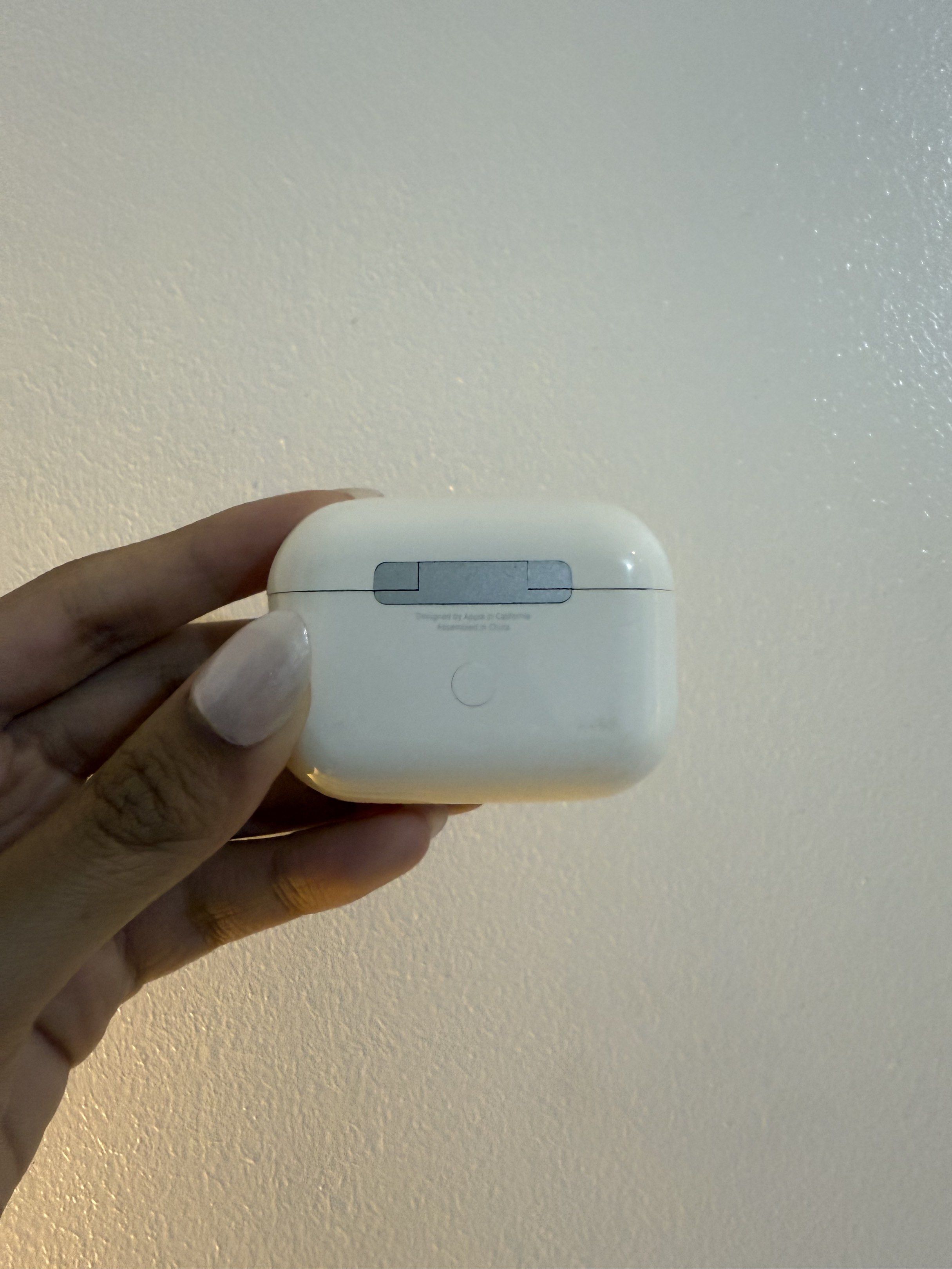 Apple AirPods Pro 2 Charging Case ONLY (Category: Earphones) located in Pasig City. Submitted by meowstuff_ (Listing ID 1418469293, Image 2). Description: - Apple AirPods Pro 2 charging case - White color - Charging port located at the bottom - Empty case - Model number visible on the back - Designed to hold two AirPods.