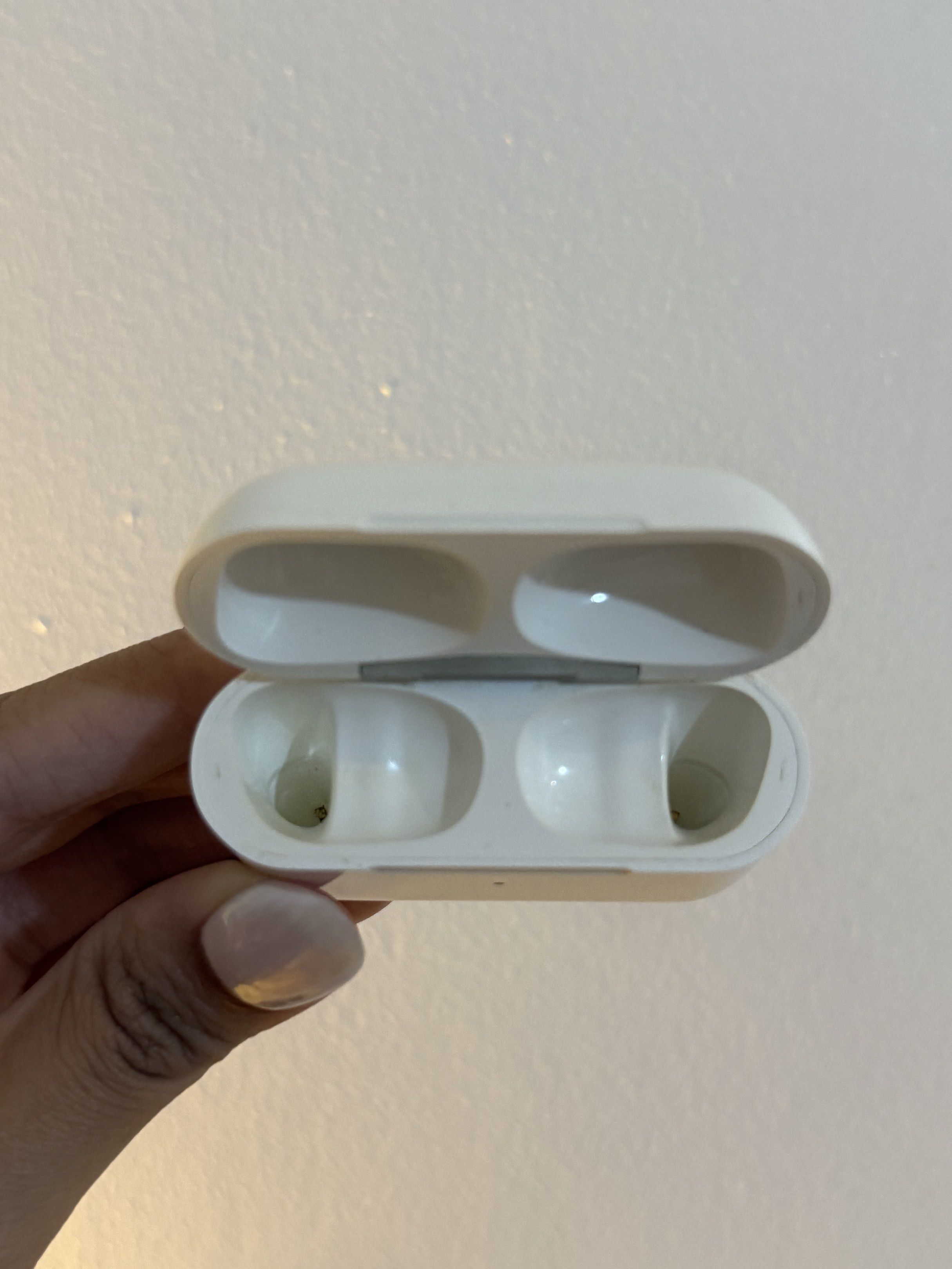 Apple AirPods Pro 2 Charging Case ONLY (Category: Earphones) located in Pasig City. Submitted by meowstuff_ (Listing ID 1418469293, Image 3). Description: - Apple AirPods Pro 2 charging case - White color - Charging port located at the bottom - Empty case - Model number visible on the back - Designed to hold two AirPods.