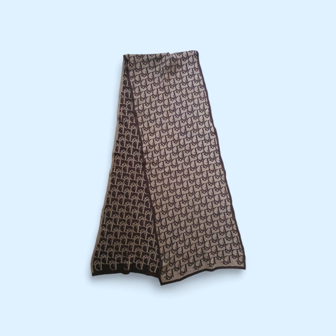 Authentic Christian Dior Oblique muffler Scarf (Category: Scarves) located in Cagayan de Oro. Submitted by real_luxe (Listing ID 1418466273, Image 2). Description: - Authentic Christian Dior scarf - Features the iconic Oblique pattern - Made in Italy - Color scheme: Brown and beige - Brand tag visible - Made of a soft, luxurious material.