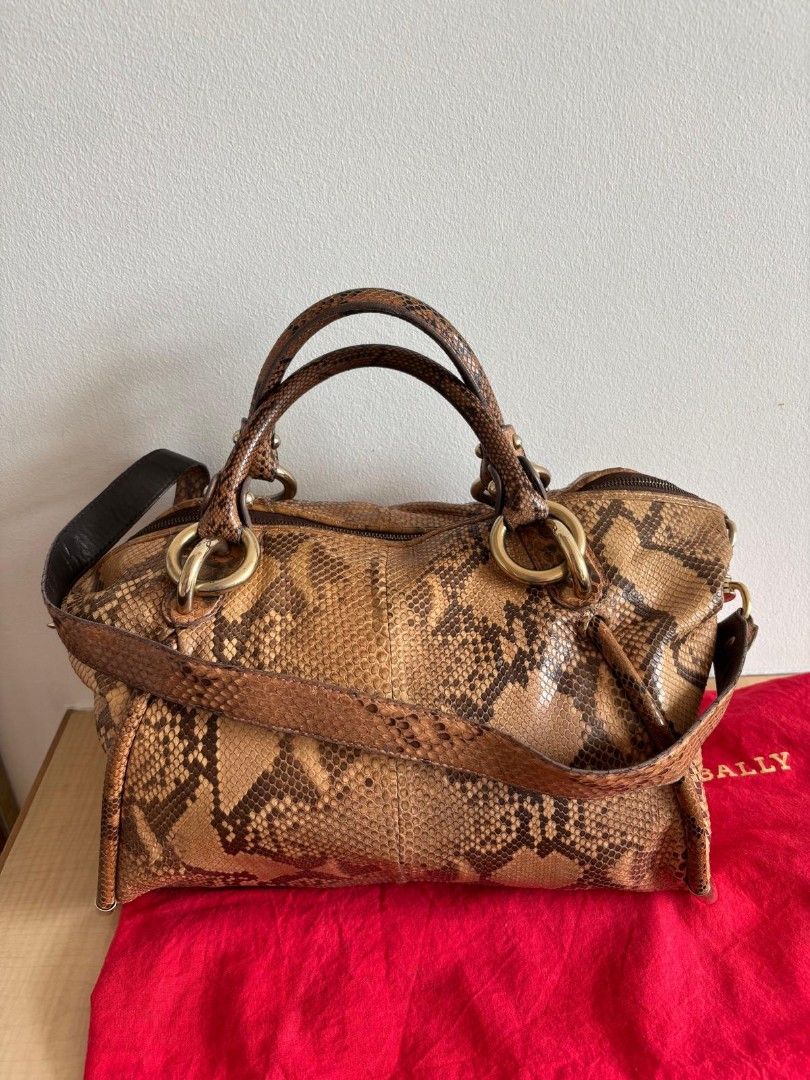 Bally Python Leather Handbag (Category: Bags & Wallets) located in Singapore. Submitted by fordmustang111 (Listing ID 1418536608, Image 1). Description: Authentic Bally handbag crafted from genuine python leather. Features a top handle and a detachable shoulder strap. Brown and black snake skin Bally with sling l39 w21 h30 cm Includes a dust bag..
