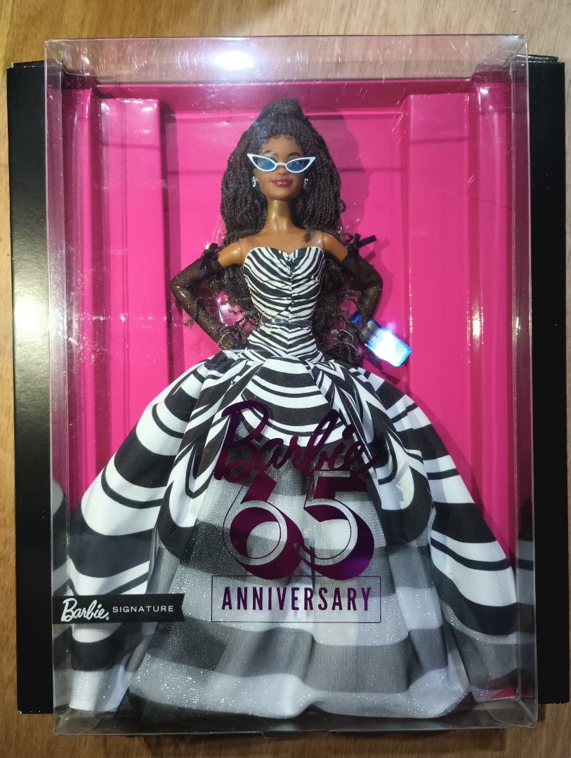 Barbie 65th Anniversary Black version AA (Category: Figurines & Statues) located in Marilao. Submitted by rare_toys_ph (Listing ID 1418547160, Image 1). Description: -NRFB - A tribute to the original swimsuit 1959 barbie. - Box is in very good condition -Very beautiful in person Payment via Gcash or Lalamove Shipping via Jnt or Lalamove.