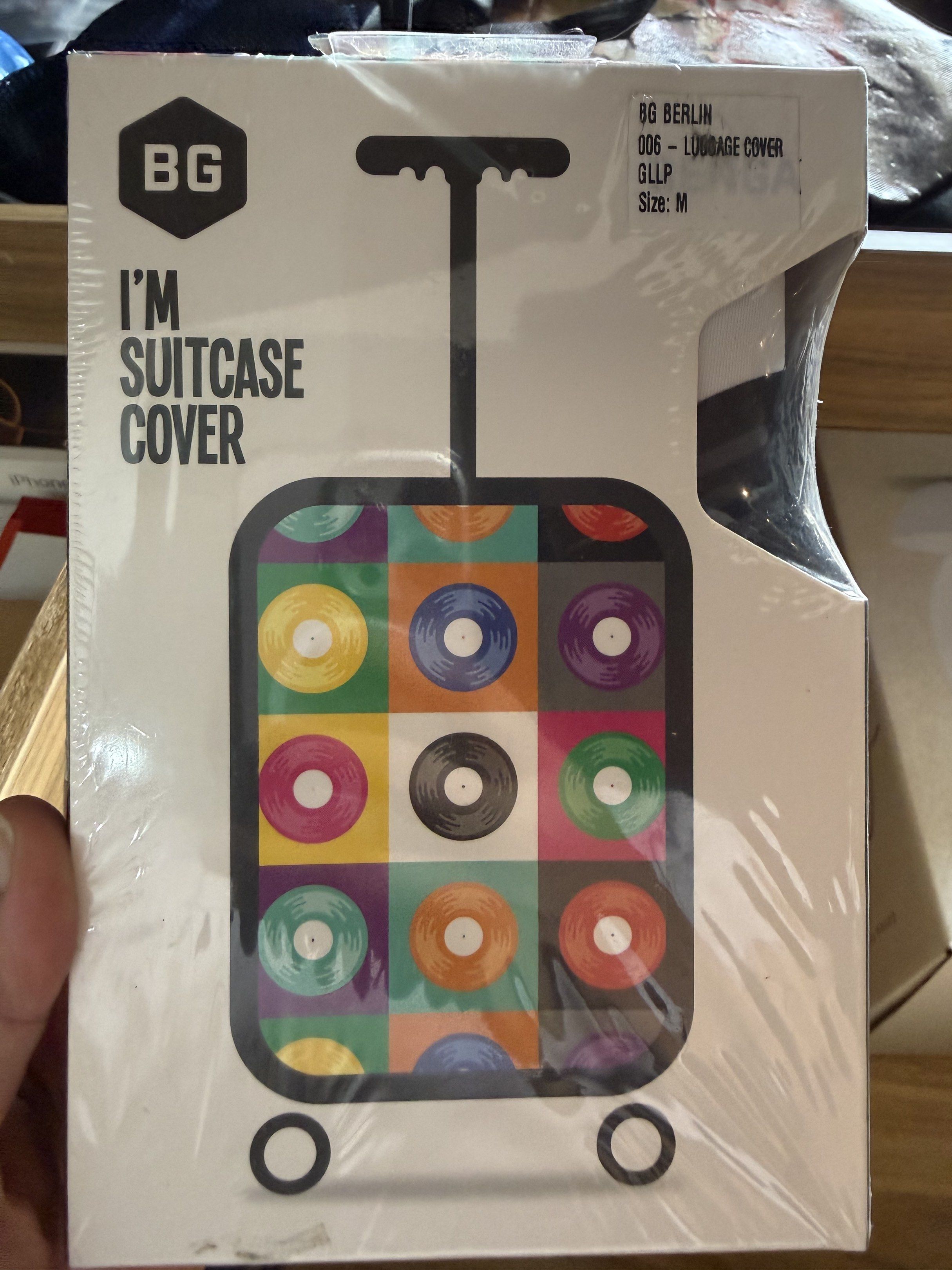 BG Berlin Luggage Cover - Size M (Category: Luggage) located in Manila. Submitted by daveeh (Listing ID 1418468673, Image 1). Description: BG Berlin luggage cover with a colorful vinyl record design. Size M, suitable for luggage sizes 62cm (17-21 inches), 62cm (22-24 inches), and 73cm (26-29 inches). Made of 100% polyester spandex. The original price is P1,299.75. Brand new and still in its original packaging..