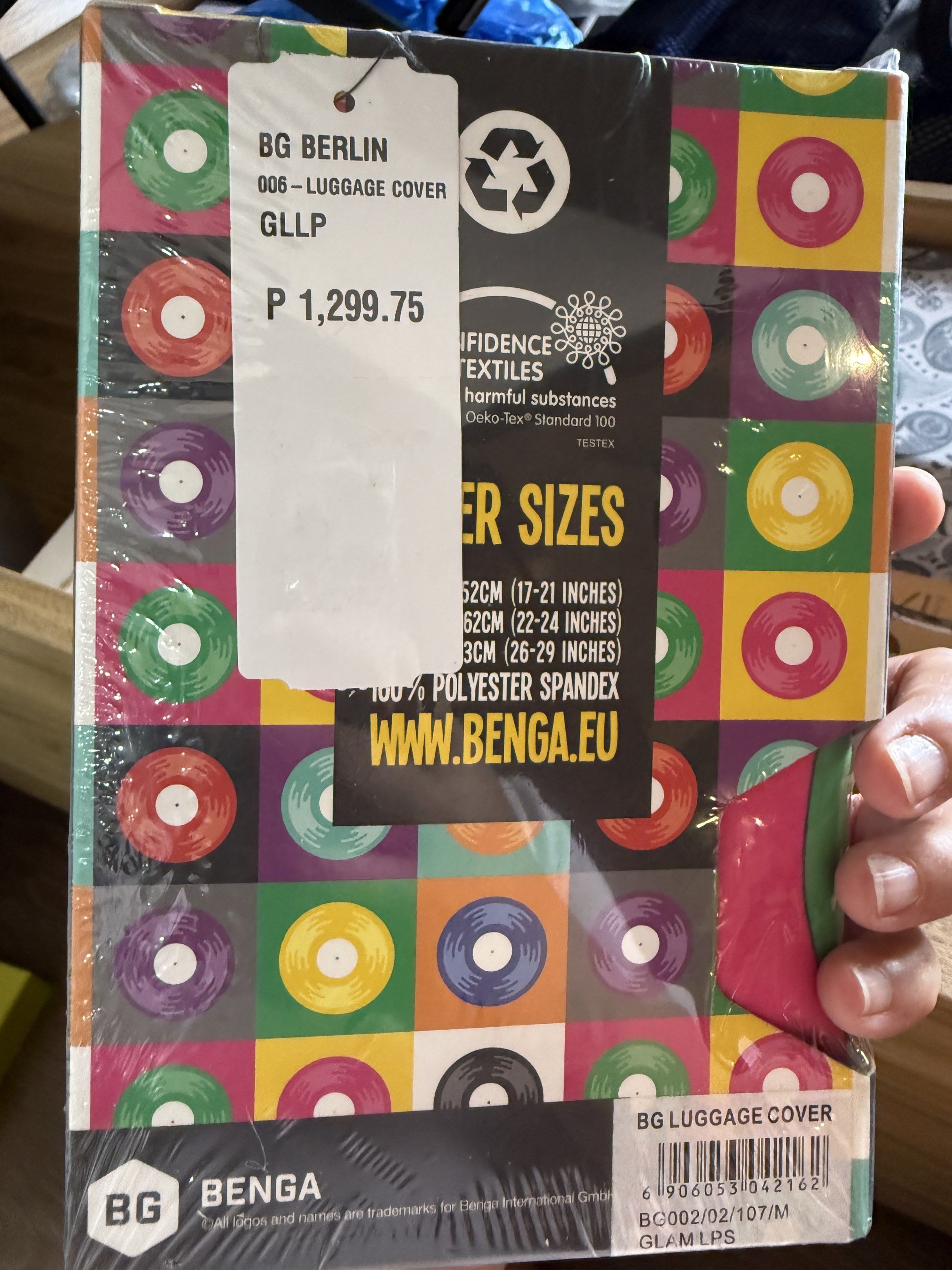 BG Berlin Luggage Cover - Size M (Category: Luggage) located in Manila. Submitted by daveeh (Listing ID 1418468673, Image 2). Description: BG Berlin luggage cover with a colorful vinyl record design. Size M, suitable for luggage sizes 62cm (17-21 inches), 62cm (22-24 inches), and 73cm (26-29 inches). Made of 100% polyester spandex. The original price is P1,299.75. Brand new and still in its original packaging..