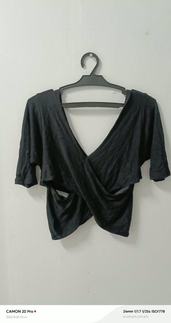 Black Criss Cross Top (Category: Sleeveless) located in Quezon City. Submitted by sheila0721 (Listing ID 1418463038, Image 1). Description: - Black top with criss-cross design - Features short sleeves - Flattering silhouette - Made of soft, draping fabric - Versatile for casual or dressy wear.