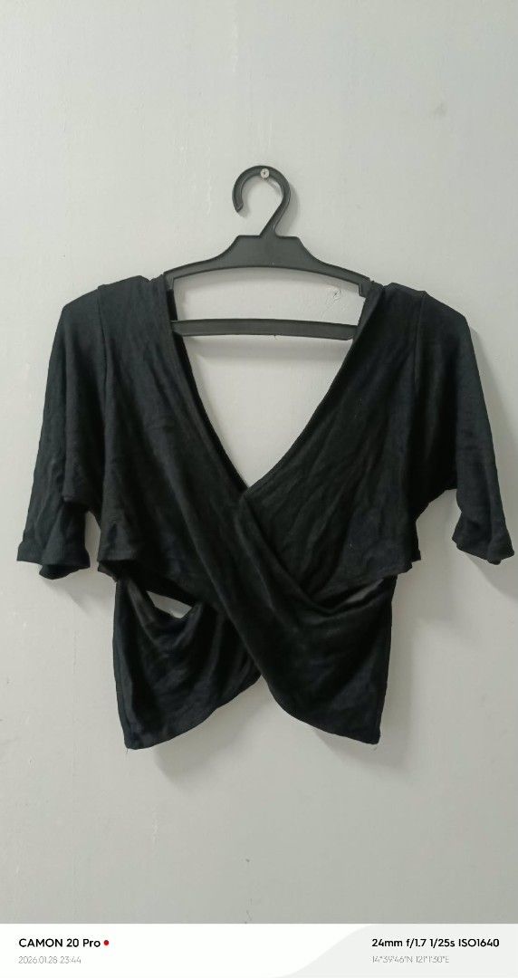 Black Criss Cross Top (Category: Sleeveless) located in Quezon City. Submitted by sheila0721 (Listing ID 1418463038, Image 2). Description: - Black top with criss-cross design - Features short sleeves - Flattering silhouette - Made of soft, draping fabric - Versatile for casual or dressy wear.
