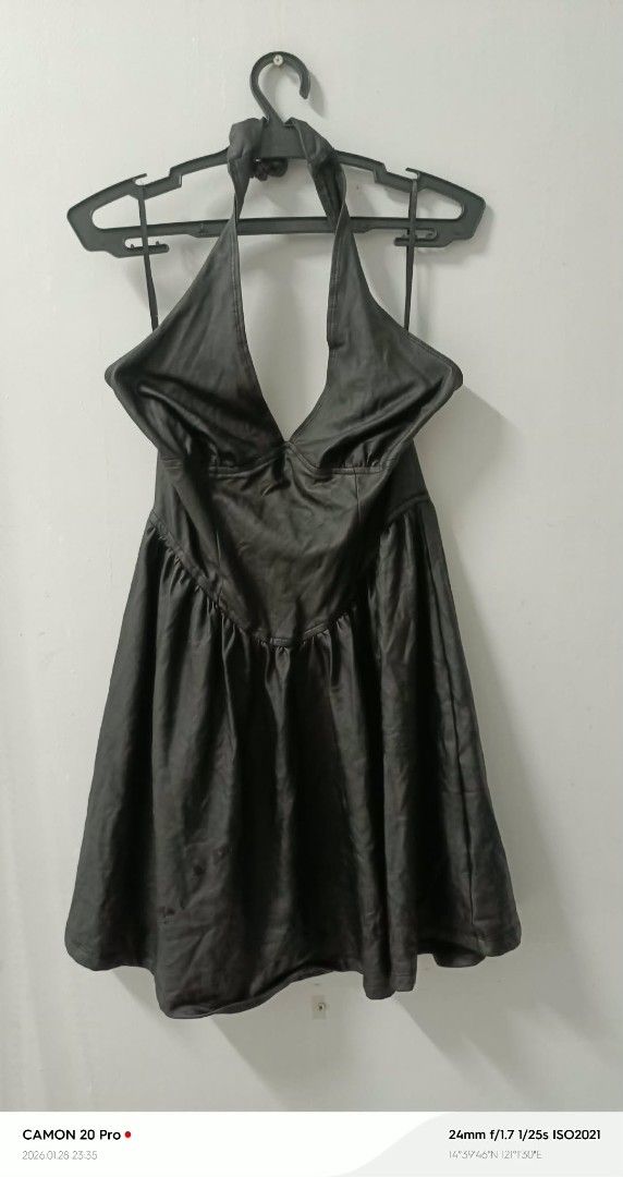 Black Halter Dress (Category: Dresses) located in Quezon City. Submitted by sheila0721 (Listing ID 1418464185, Image 1). Description: - Black halter dress - Plunging neckline - Flared skirt - Halter neck tie - Smooth, possibly synthetic material - Suitable for various occasions.
