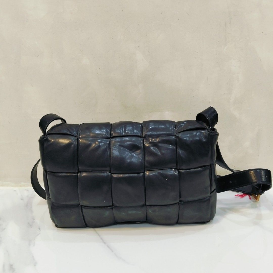 Bottega Veneta Padded Cassette Bag (Category: Luxury Bags & Wallets) located in Dagupan City. Submitted by youngthrift_ (Listing ID 1418497871, Image 1). Description: - Bottega Veneta Padded Cassette Bag - Color: Black - Design: Woven - Hardware: Gold-tone - Interior: Zipper pocket - Made in Italy - Shoulder strap included - Serial number: B00881424X - issue sign of used.