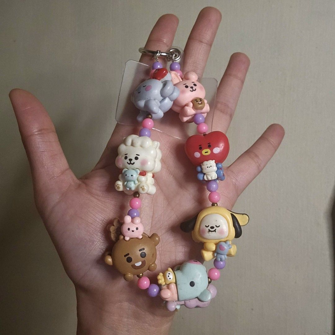 BT21 Character Keychain, Phone or Bagcharm (Category: Charms) located in Las Pinas. Submitted by klya00 (Listing ID 1418450016, Image 2). Description: - Features all BT21 characters: Tata, Chimmy, Cooky, Shooky, Mang, Koya, and RJ. - Decorated with pink and purple beads. - Includes a silver clasp for easy attachment and phone tab to use as a phone charm. - Handmade.