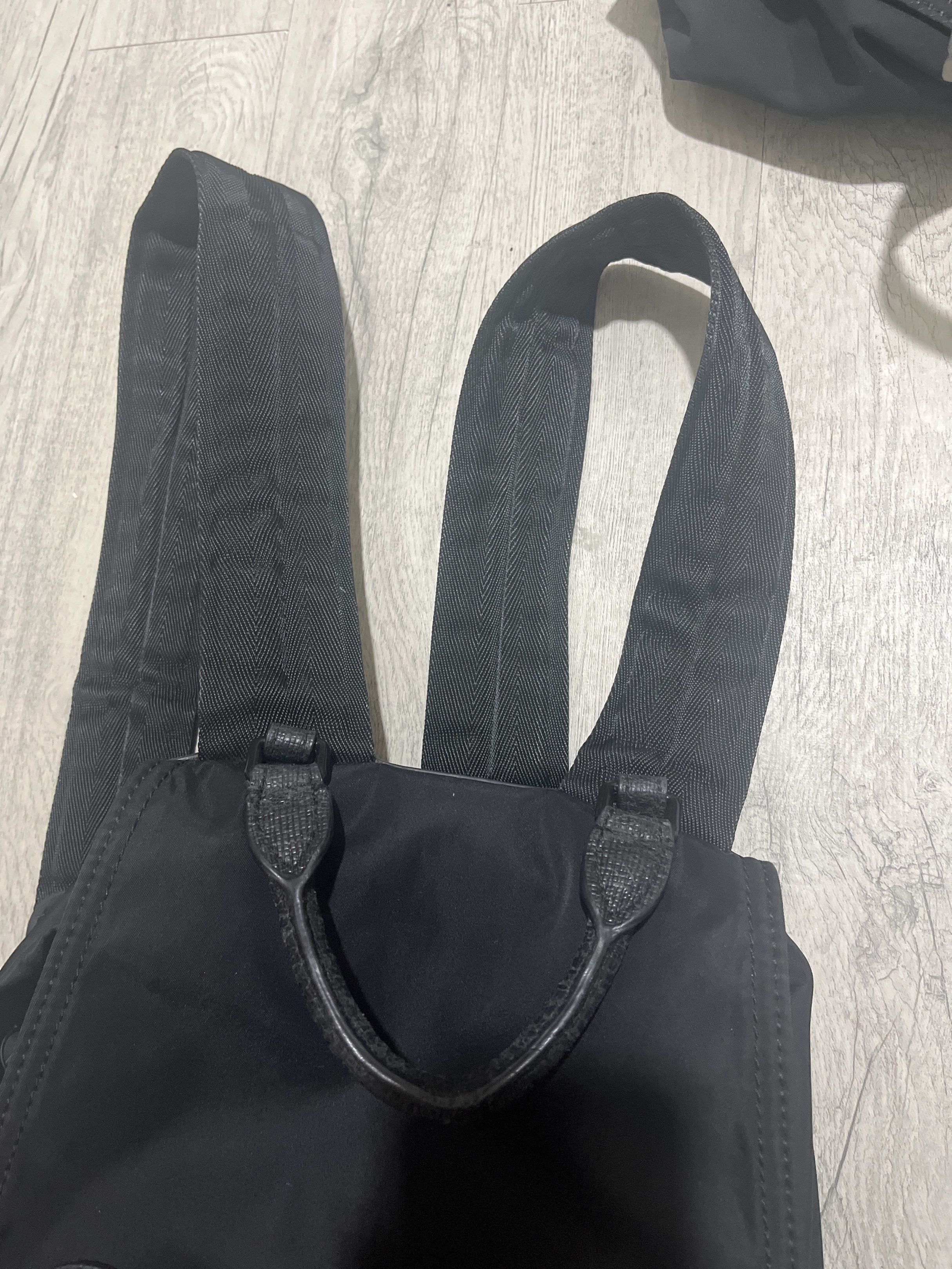Original Burberry Black Backpack (Category: Luxury Bags & Wallets) located in Mandaluyong City. Submitted by lopezsam (Listing ID 1418543118, Image 3). Description: Features a drawstring closure, front pocket, and side pockets. The backpack has leather accents and adjustable straps. The interior has a Burberry label. The back of the backpack has a quilted design. Includes a top handle for carrying..