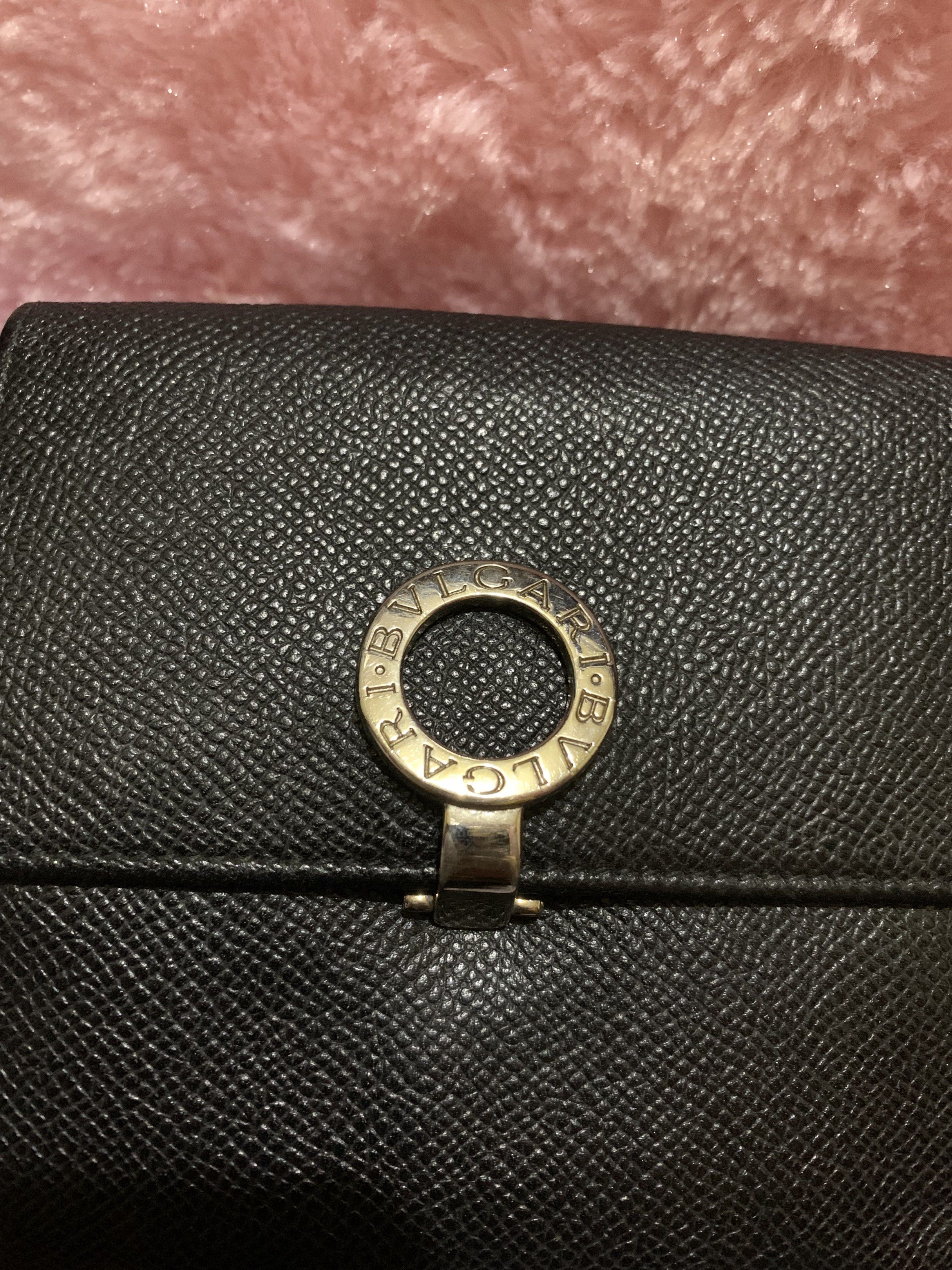 Bvlgari Black Leather Wallet (Category: Luxury Bags & Wallets) located in Quezon City. Submitted by ncjnc (Listing ID 1418555472, Image 1). Description: - Authentic Bvlgari wallet - Black leather - Silver-tone clasp - Multiple card slots - Coin compartment - "BVLGARI MADE IN ITALY" embossed inside - High-quality, textured leather.