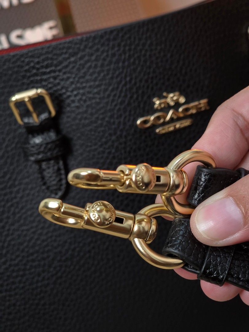 Coach Mollie 25 Tote Bag (Category: Luxury Bags & Wallets) located in Pasig City. Submitted by maryjanegr (Listing ID 1418453639, Image 3). Description: - Black Coach tote bag - Red interior - Detachable straps - Gold-tone hardware - Coach hang tag included - Made of textured leather.