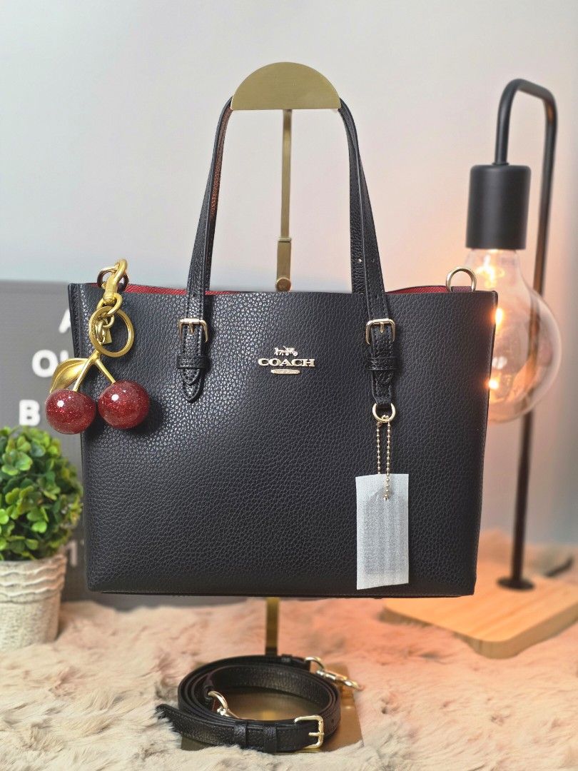 Coach Mollie 25 Tote Bag (Category: Luxury Bags & Wallets) located in Pasig City. Submitted by maryjanegr (Listing ID 1418453639, Image 1). Description: - Black Coach tote bag - Red interior - Detachable straps - Gold-tone hardware - Coach hang tag included - Made of textured leather.