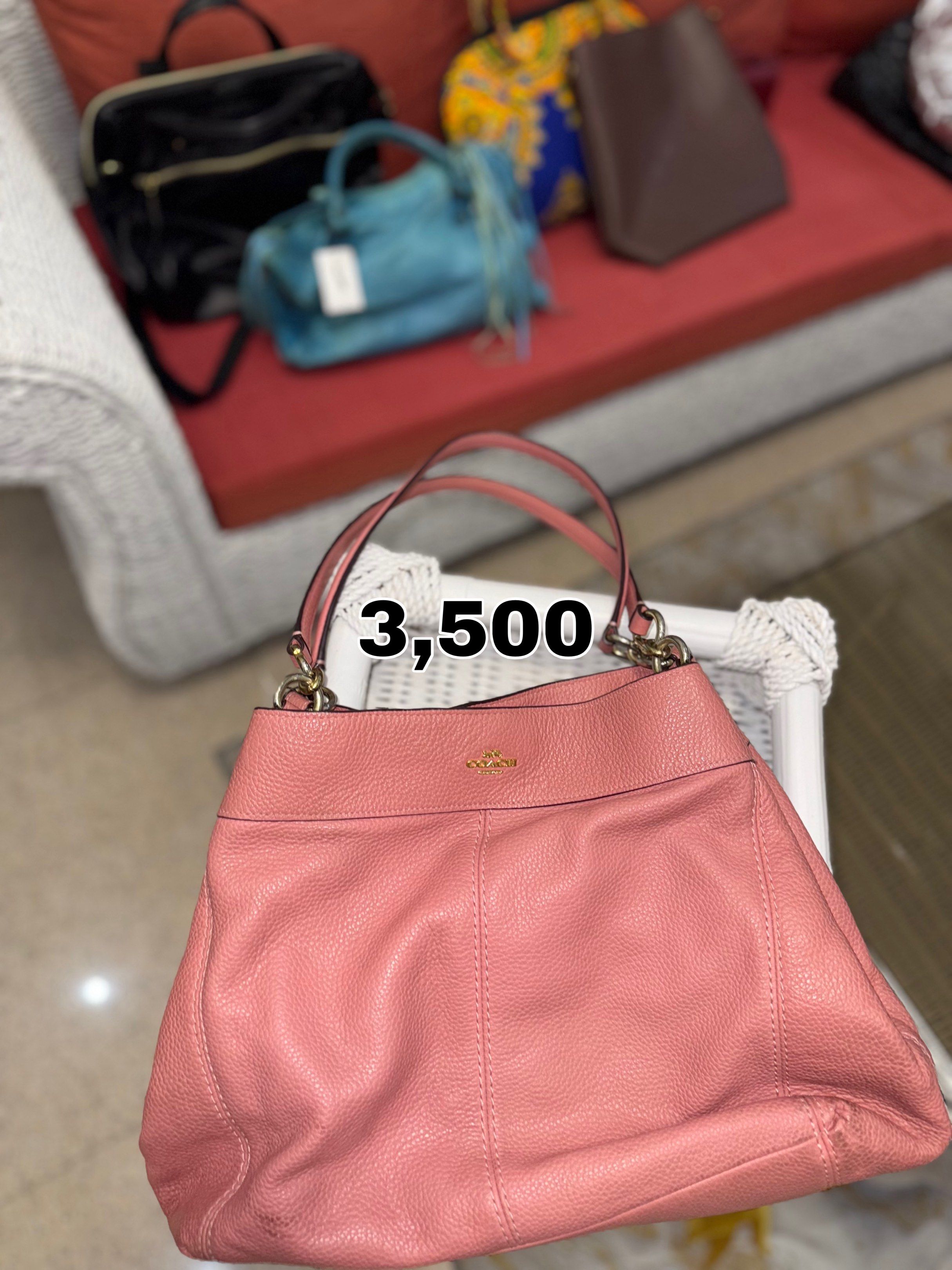 Coach Pink Leather Handbag (Category: Luxury Bags & Wallets) located in Manila. Submitted by andreaaarut (Listing ID 1418514349, Image 1). Description: - Authentic Coach handbag - Soft pink color - Spacious interior - Double handles - Subtle Coach logo - Textured leather.