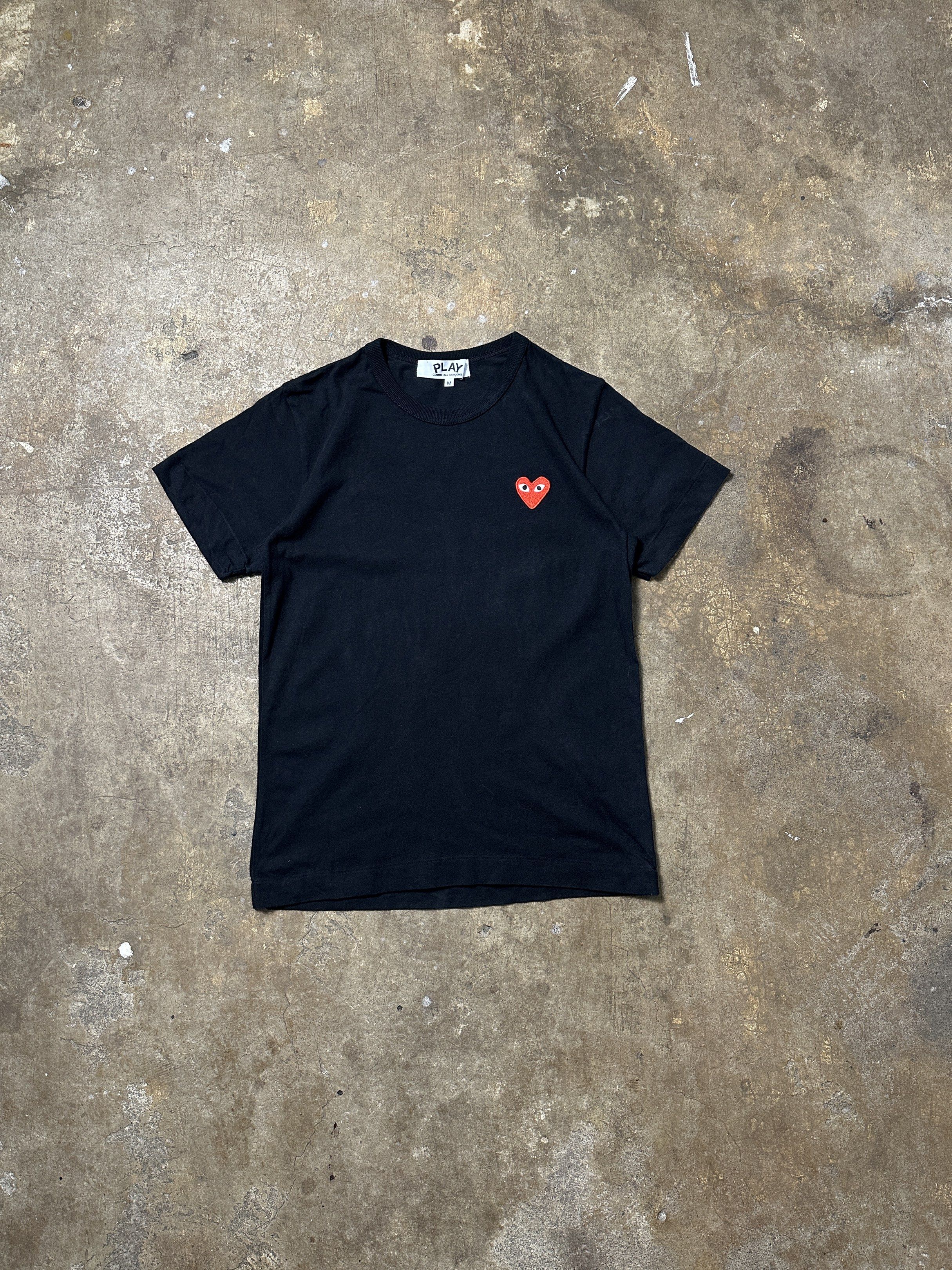 Comme des Garcons Play Heart Tee - Black (Category: Shirts) located in Bacolod City. Submitted by thestitchph (Listing ID 1418445970, Image 1). Description: - Authentic Comme des Garcons Play T-shirt - Color: Black - Size: M - Features the iconic red heart logo - Made in Japan - Material: 100% Cotton - Includes care instructions Size medium women 18x25 Excellent.