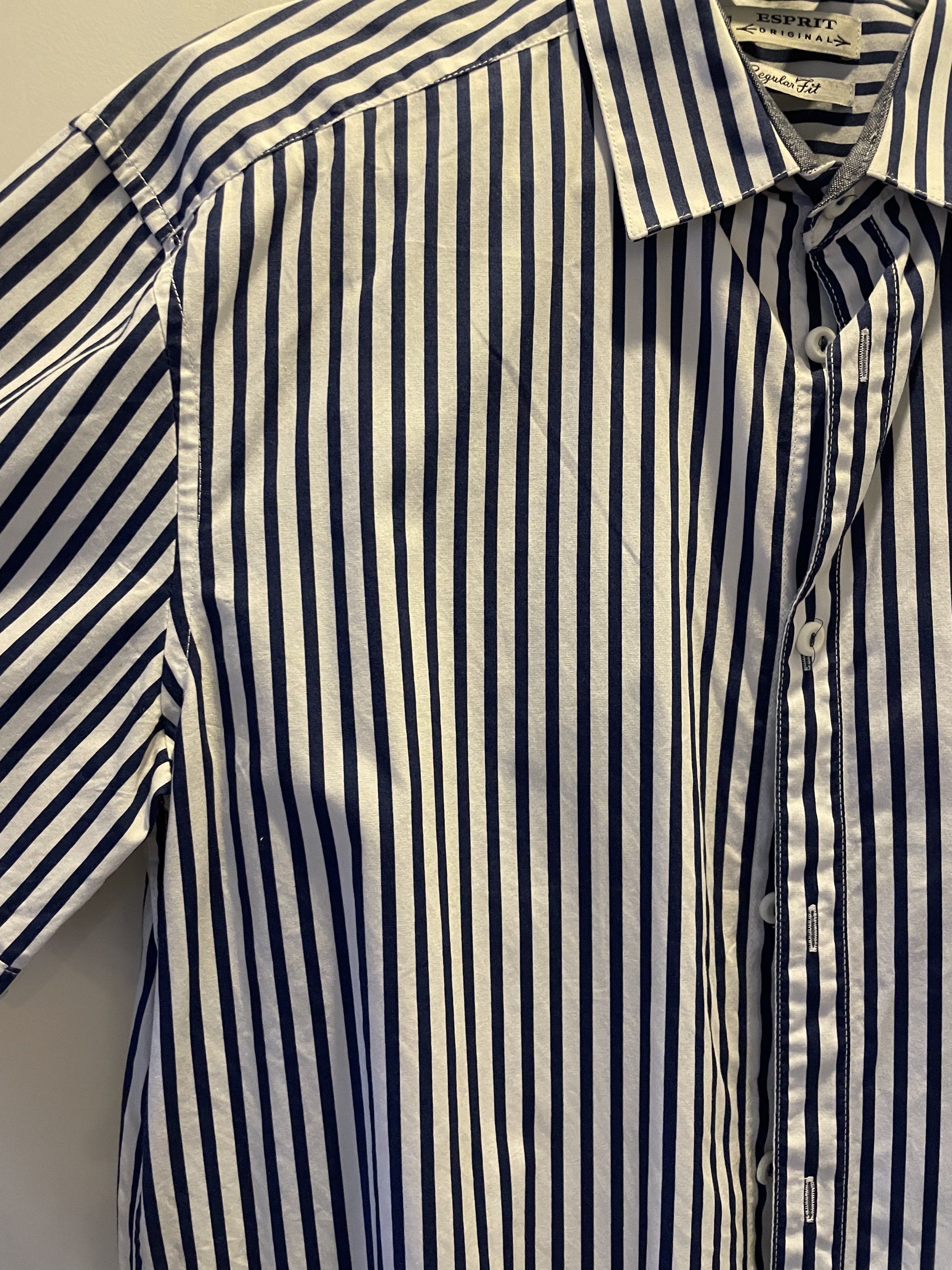Esprit Original Regular Fit Striped Shirt (Category: Tshirts & Polo Shirts ) located in Las Pinas. Submitted by bmtl_ (Listing ID 1418525880, Image 3). Description: - Esprit Original shirt - Regular fit - Classic collar - Short sleeves - Button-down closure - White with navy blue vertical stripes RFS: Decluttering, used once.