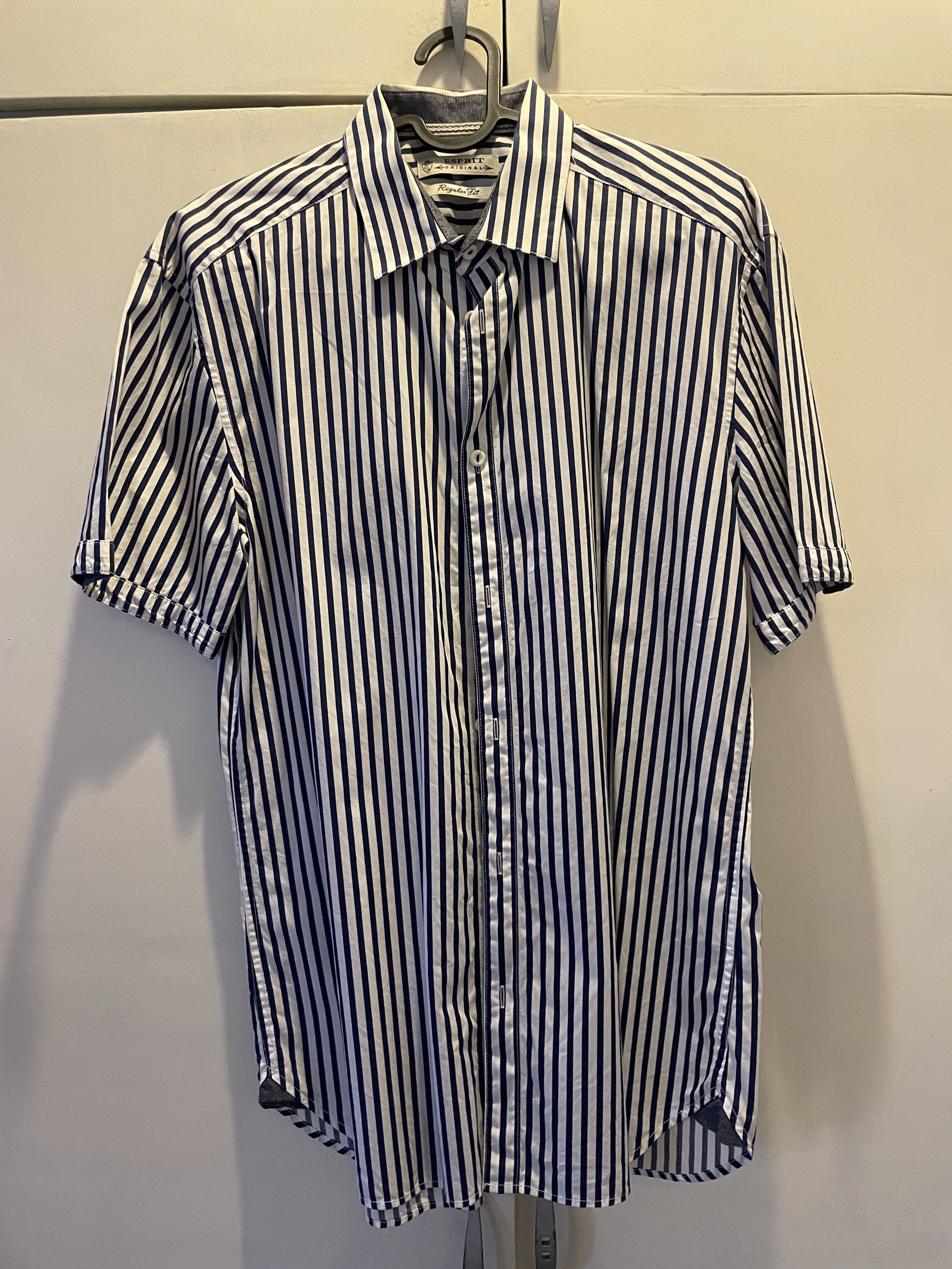 Esprit Original Regular Fit Striped Shirt (Category: Tshirts & Polo Shirts ) located in Las Pinas. Submitted by bmtl_ (Listing ID 1418525880, Image 1). Description: - Esprit Original shirt - Regular fit - Classic collar - Short sleeves - Button-down closure - White with navy blue vertical stripes RFS: Decluttering, used once.