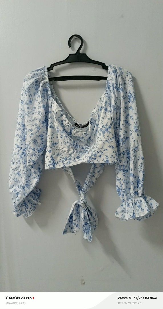 Floral Tie-Back Crop Top (Category: Blouses) located in Quezon City. Submitted by sheila0721 (Listing ID 1418464341, Image 2). Description: - Floral print crop top - Blue and white design - Long sleeves with ruffled cuffs - Tie-back detail - V-neckline - Cropped length - Lightweight and comfortable fabric - Suitable for casual or special events.
