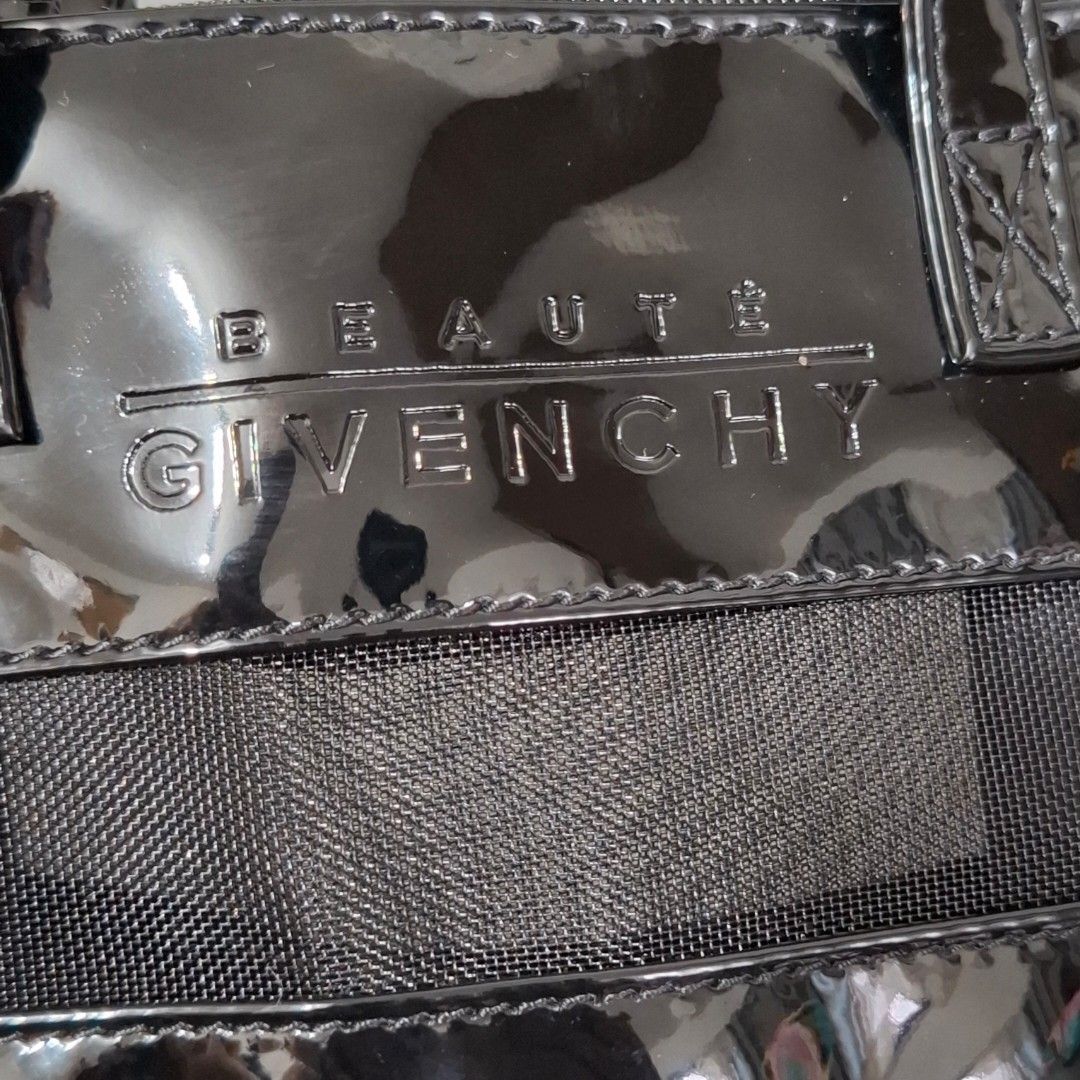 Givenchy Beauté Black Handbag (Category: Luxury Bags & Wallets) located in Don Carlos. Submitted by PphiXi_Finds (Listing ID 1418444508, Image 2). Description: - Black Givenchy Beauté cute or small handbag - Glossy finish with mesh panel - Includes a small mirror tag - Top zipper closure - Two handles - Black interior - Givenchy Beauté logo visible.