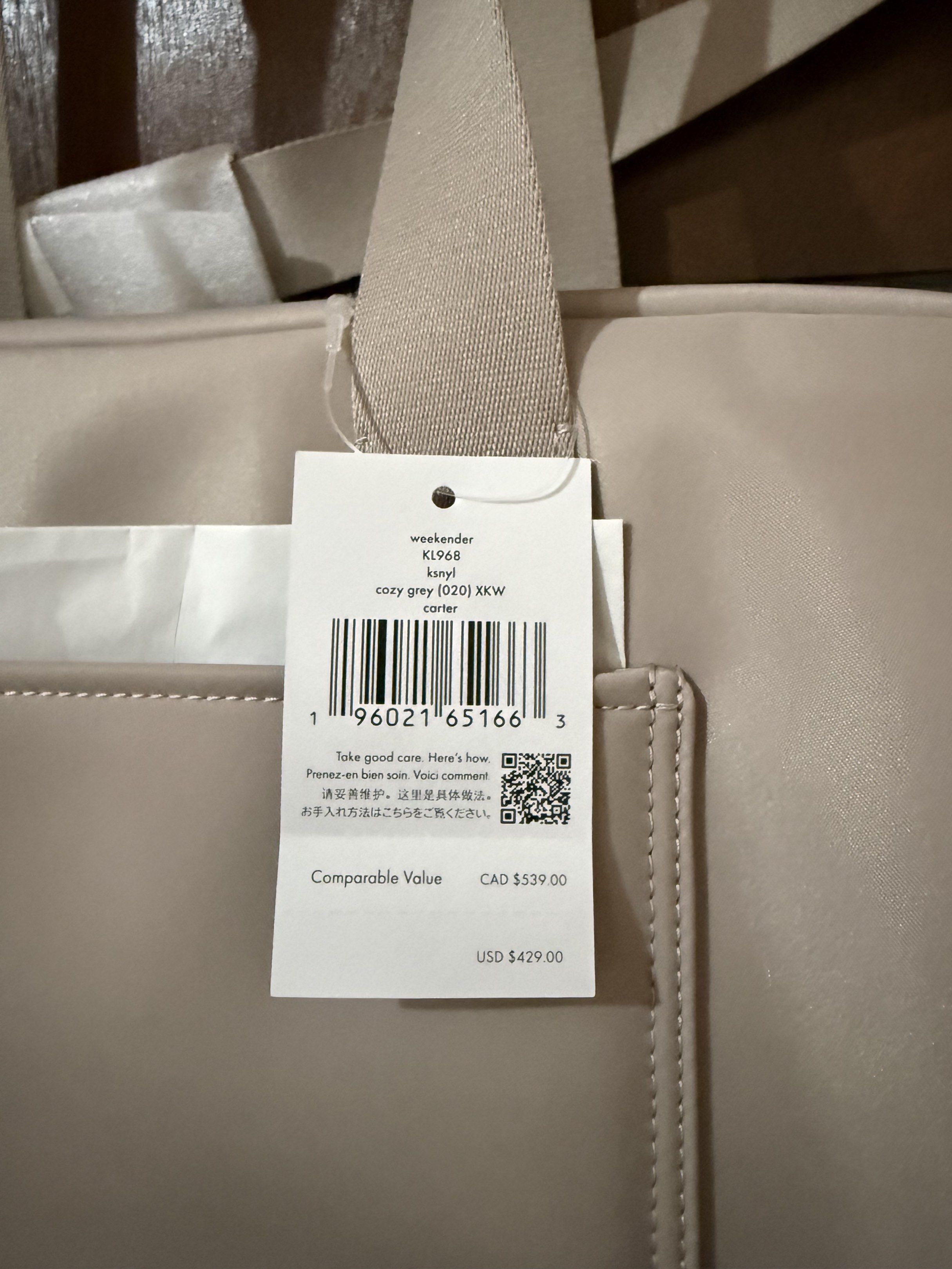 Kate Spade Weekender Bag (Category: Luxury Bags & Wallets) located in Paranaque City. Submitted by aaaaa_earth (Listing ID 1418541606, Image 3). Description: Kate Spade Weekender bag is a stylish and spacious carryall. It features a neutral color, a shoulder strap, and tote handles. The bag has the Kate Spade logo on the front and on the strap. The bag has a large main compartment and an exterior pocket. Color: Cozy Grey .
