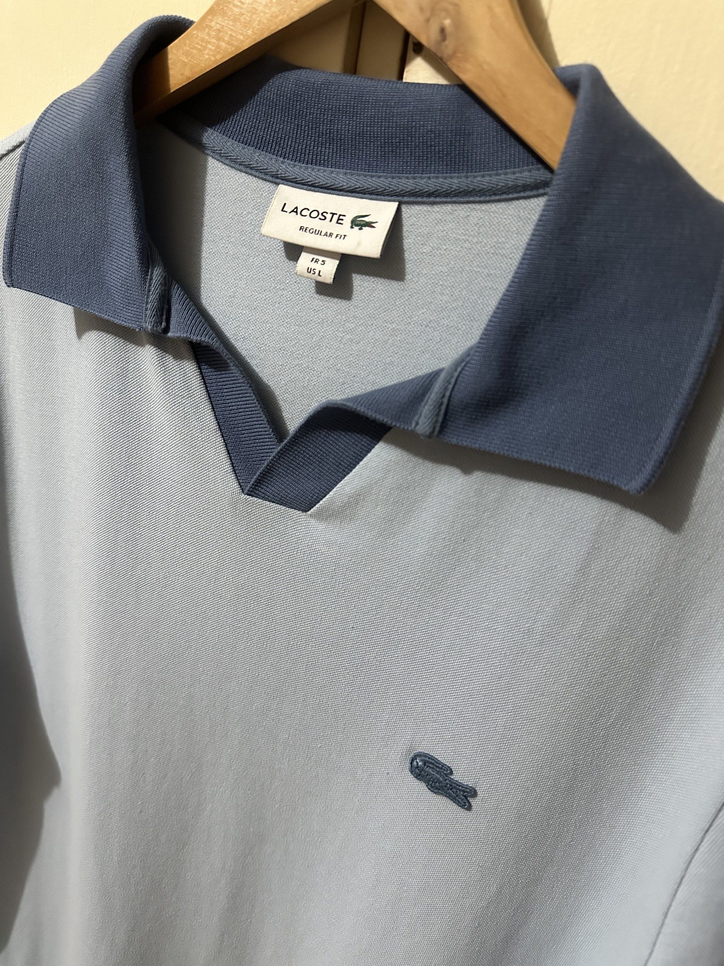 Lacoste Regular Fit Polo Shirt (Category: Tshirts & Polo Shirts ) located in Manila. Submitted by 4buying (Listing ID 1418416523, Image 2). Description: - Lacoste polo shirt - Light blue color - Size: L - Unique collar design - Iconic crocodile logo - Regular fit - 100% cotton - Darker blue collar and cuffs 27 x 22.