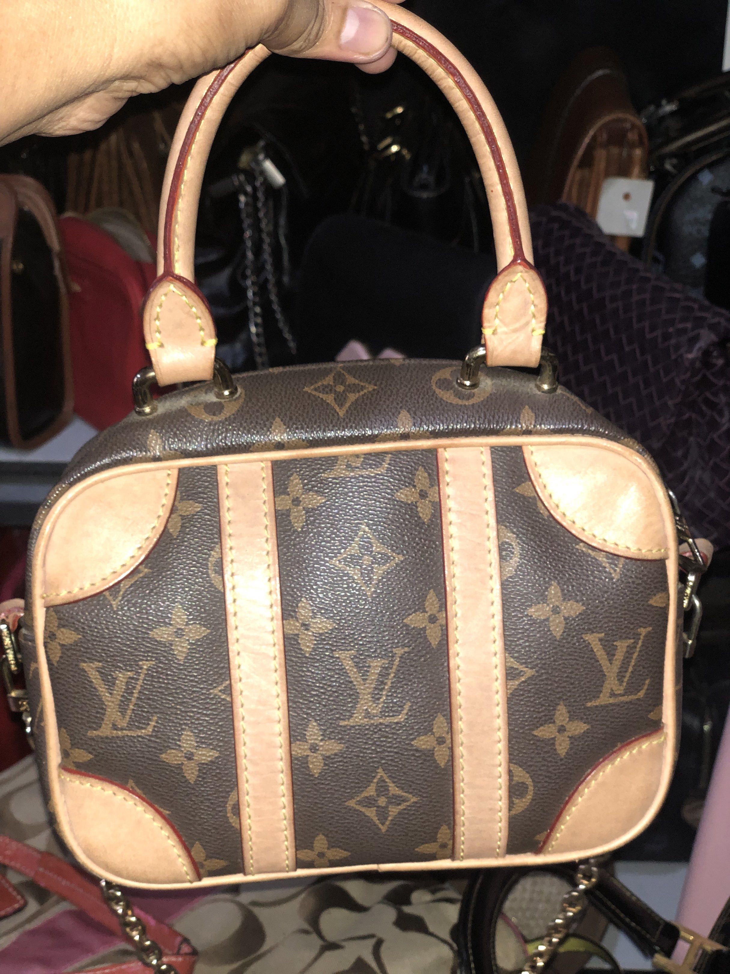 Louis Vuitton Mini Papillon Handbag (Category: Luxury Bags & Wallets) located in Davao. Submitted by deinlakarol19 (Listing ID 1418437191, Image 3). Description: - Authentic Louis Vuitton Mini Papillon - Iconic monogram canvas - Tan leather accents and handles - Gold-tone chain strap included - Brown fabric lining with interior pocket - Gold-toned zipper closure - Classic barrel shape.