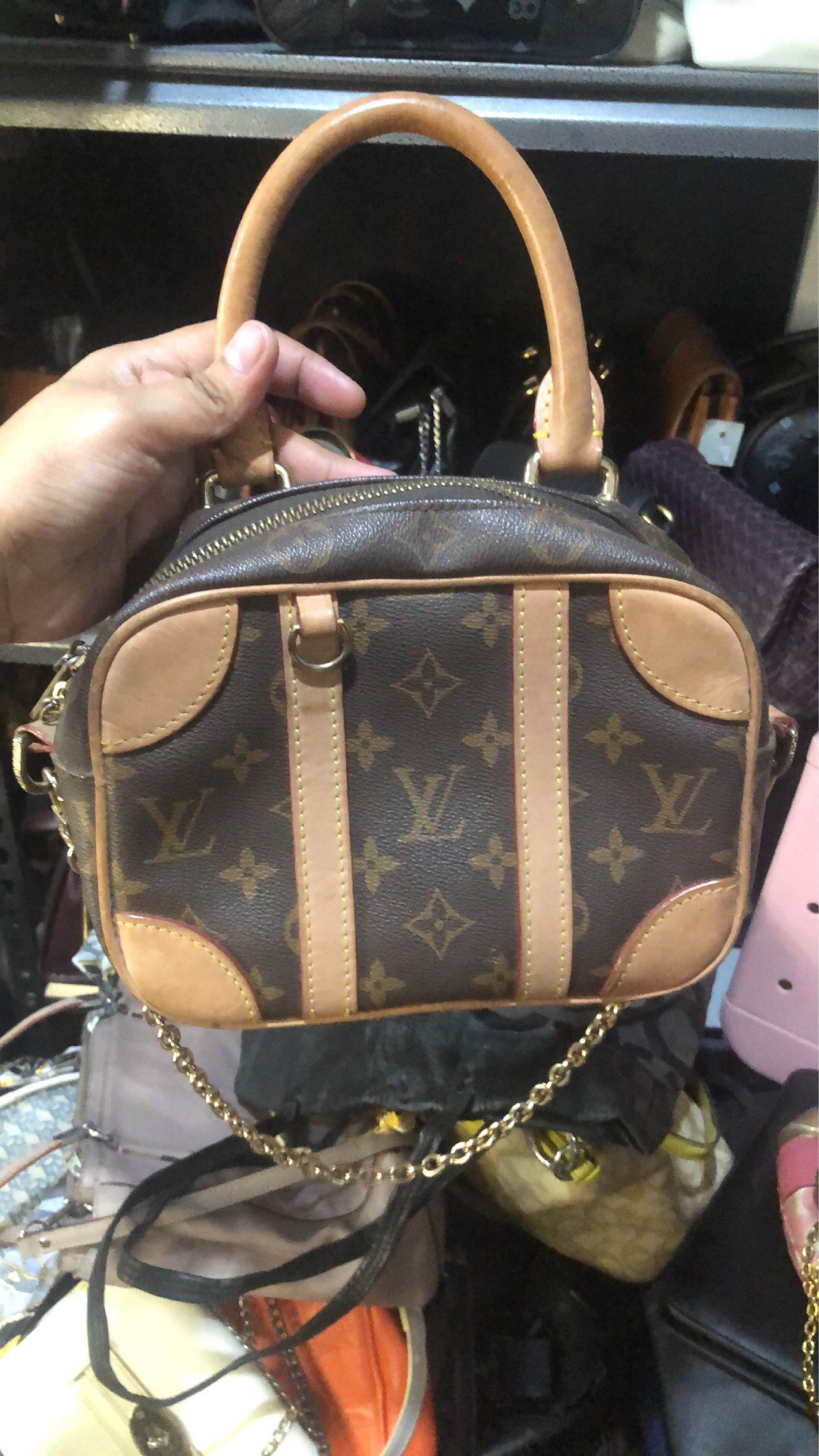 Louis Vuitton Mini Papillon Handbag (Category: Luxury Bags & Wallets) located in Davao. Submitted by deinlakarol19 (Listing ID 1418437191, Image 1). Description: - Authentic Louis Vuitton Mini Papillon - Iconic monogram canvas - Tan leather accents and handles - Gold-tone chain strap included - Brown fabric lining with interior pocket - Gold-toned zipper closure - Classic barrel shape.