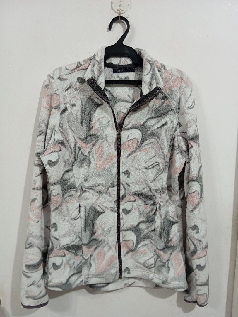 Marks & Spencer Collection Fleece Jacket M&S (Category: Coats, Jackets and Outerwear) located in Muntinlupa City. Submitted by challasy (Listing ID 1418573513, Image 2). Description: M&S Collection fleece jacket features a unique pattern in shades of gray, pink, and white. It has a full zip closure, two front pockets, and a high collar. The jacket is a UK size 8 and EUR size 36. It is made of a soft fleece material, perfect for cooler weather..