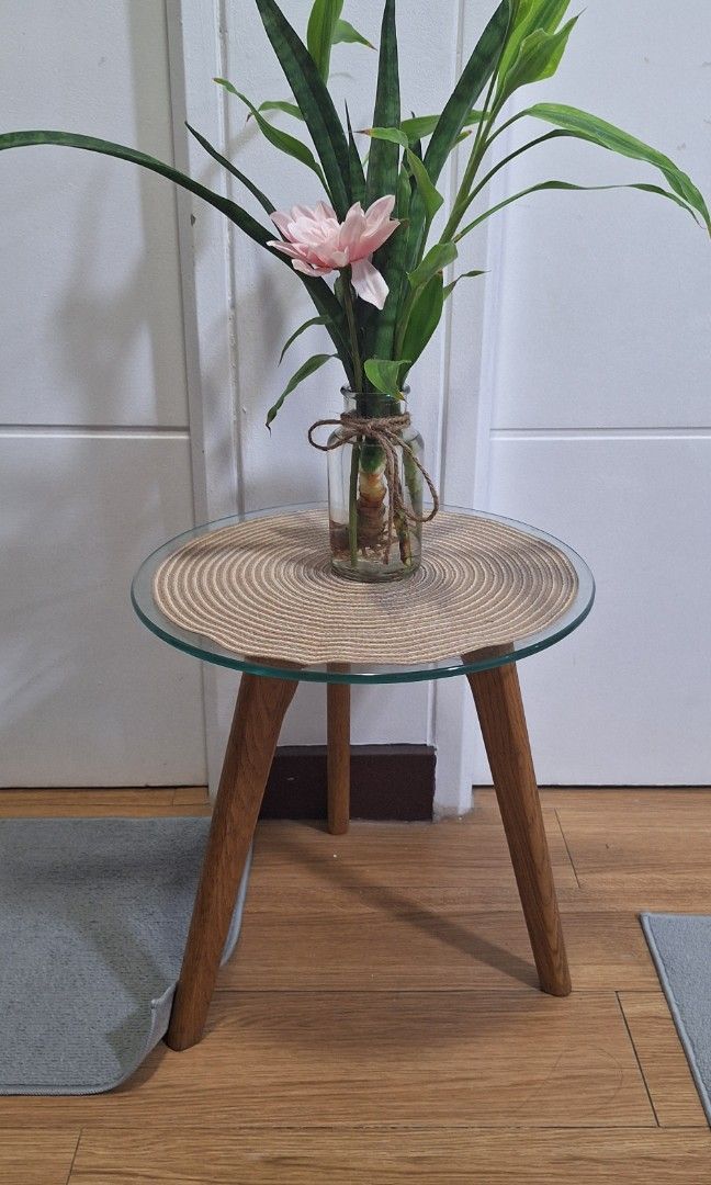 Minimalist Glass-Top Side Table (Category: Other Home Furniture) located in Makati City. Submitted by r_lopez (Listing ID 1418574837, Image 1). Description: This is a small, modern side table featuring a round glass top supported by three wooden legs in a natural finish..