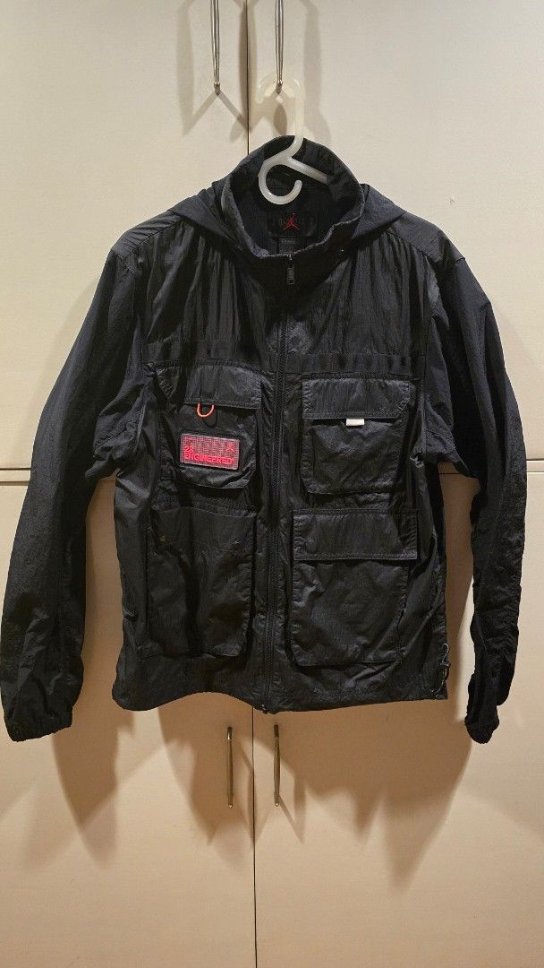 Nike Jordan 23 Engineered Jacket (Category: Coats, Jackets and Outerwear) located in Pasig City. Submitted by johnflan (Listing ID 1418589630, Image 1). Description: - Black Nike Jordan jacket - Features multiple pockets - '23 Engineered' logo on the back - Red Jordan logo patch - Includes a hood - Zipper closure - Lightweight material - Possibly water-resistant - Size tag visible.