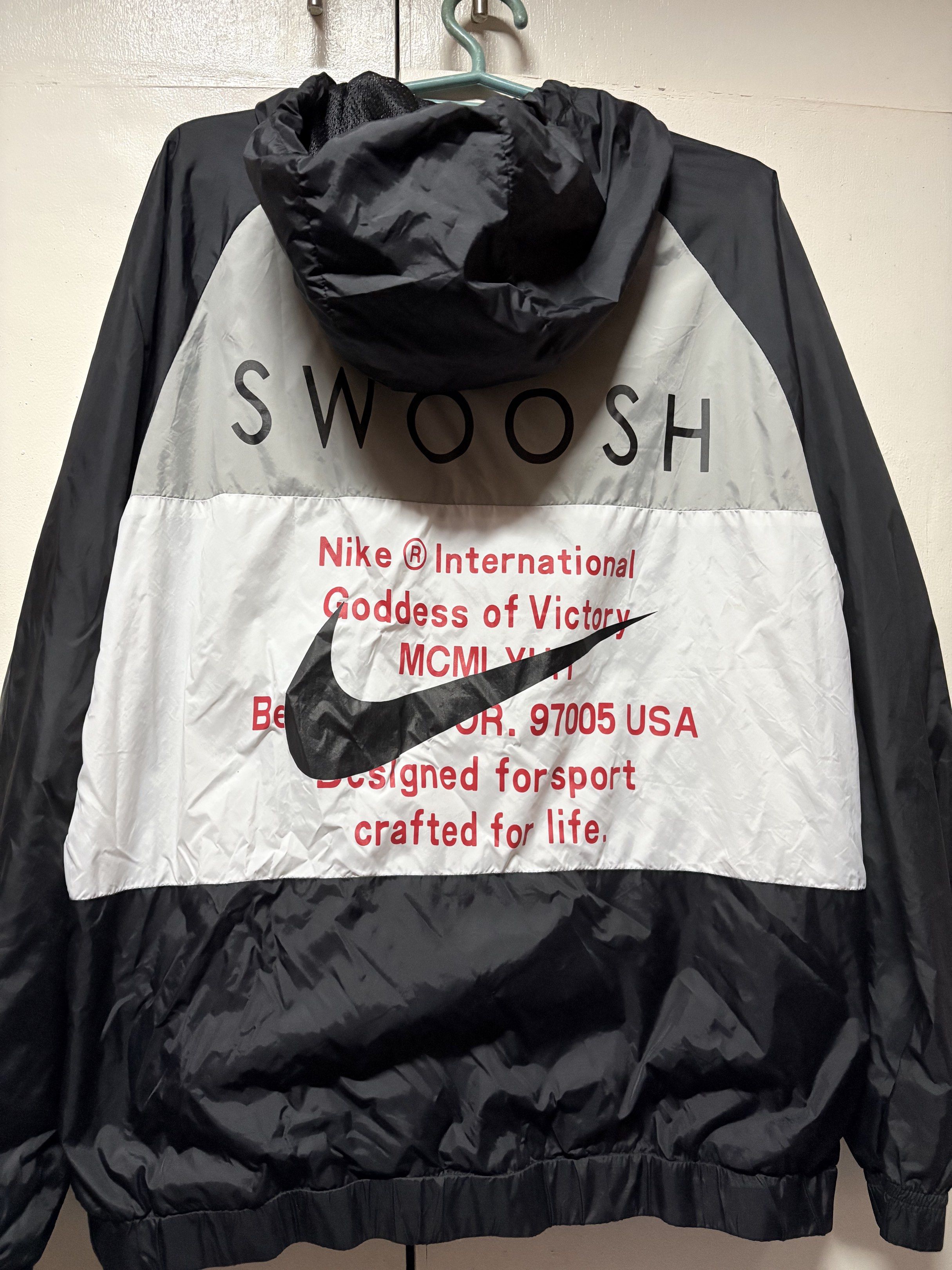 Nike Swoosh Windbreaker Jacket (Category: Coats, Jackets and Outerwear) located in Marikina City. Submitted by cleoferuzz (Listing ID 1418537947, Image 2). Description: - Nike windbreaker jacket - Size: Small - Features Nike Swoosh logo on front - "Swoosh" print and Nike logo on back - Full zip closure - Hooded slightly nego .