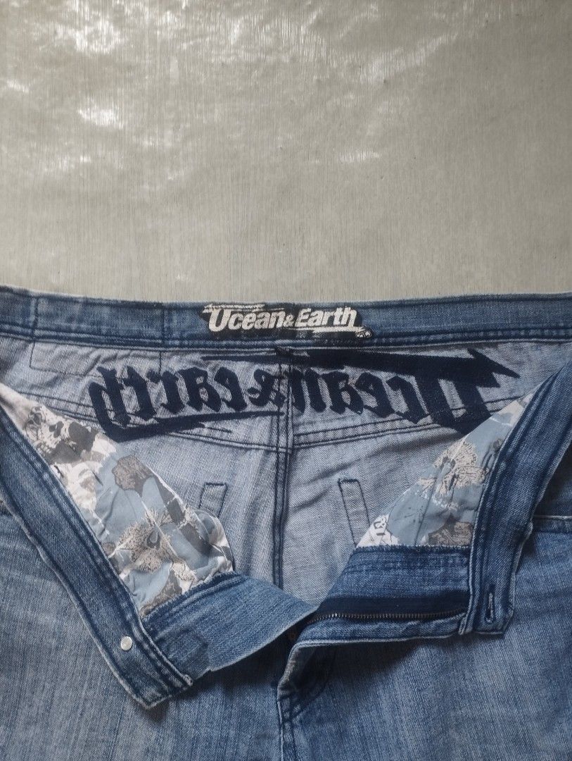 Ocean & Earth Blue Denim Shorts - Size 40 (Category: Shorts) located in Orion. Submitted by thrift___drip (Listing ID 1418467486, Image 2). Description: Ocean & Earth denim shorts Waist: 40" Length: 24.5" Hem: 13"(26") - Distressed details - Light blue wash - Relaxed fit - Brand name on back and waistband - Front and back pockets - Button and zipper closure.
