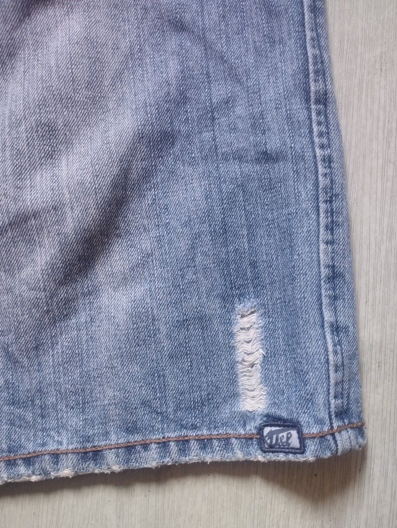 Ocean & Earth Blue Denim Shorts - Size 40 (Category: Shorts) located in Orion. Submitted by thrift___drip (Listing ID 1418467486, Image 3). Description: Ocean & Earth denim shorts Waist: 40" Length: 24.5" Hem: 13"(26") - Distressed details - Light blue wash - Relaxed fit - Brand name on back and waistband - Front and back pockets - Button and zipper closure.