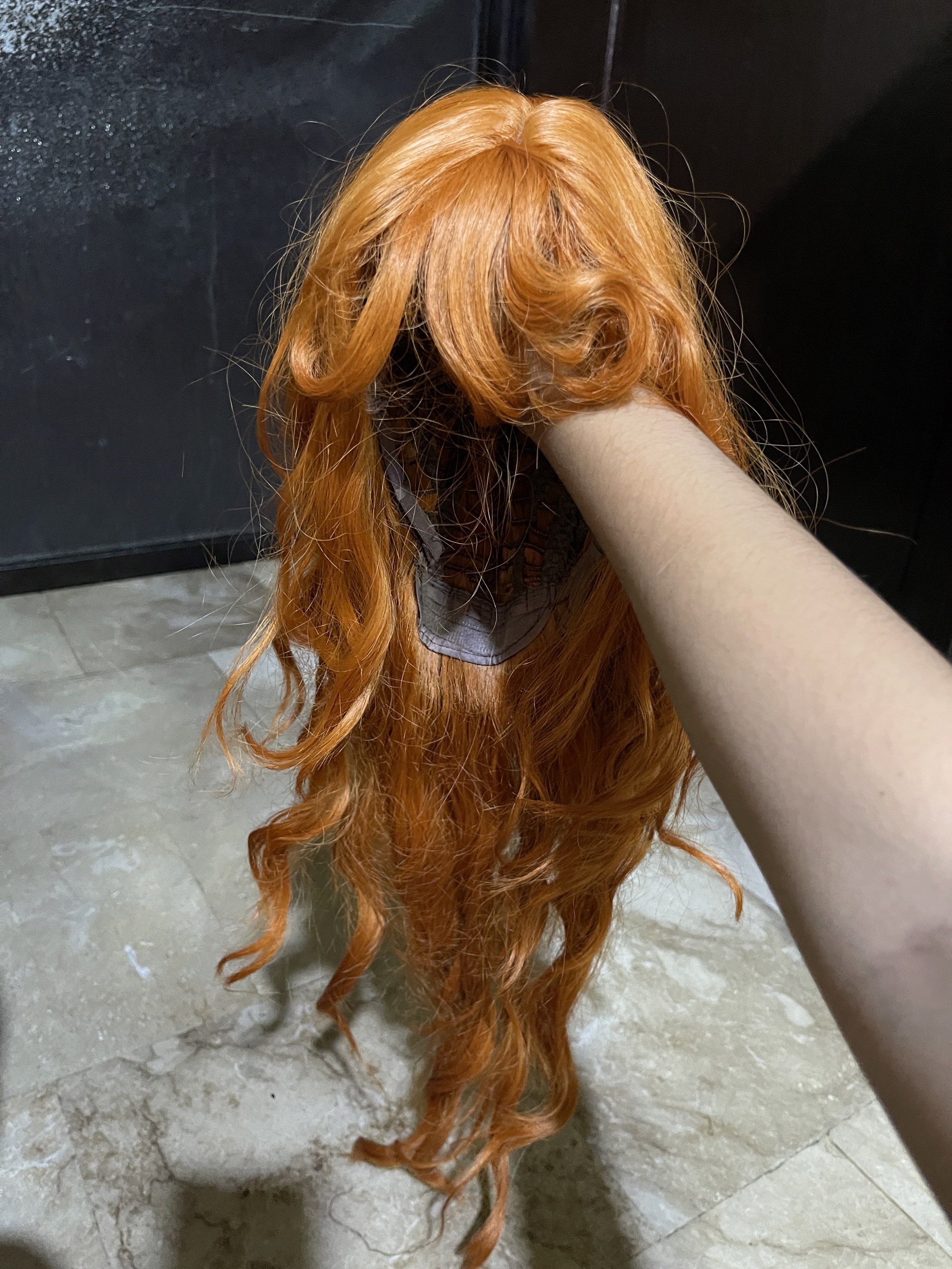 Orange Curly Wig (Category: Hair Accessories) located in Muntinlupa City. Submitted by stefdeclutters (Listing ID 1418541161, Image 2). Description: PRELOVED Long, wavy orange wig. MOST FAVE WIG OF MINE!! - 25 INCH LONG - USED THRICE , STILL IN GOOD CONDITION - NO BOX MOP: GCASH MOD: LBC or LALAMOVE.