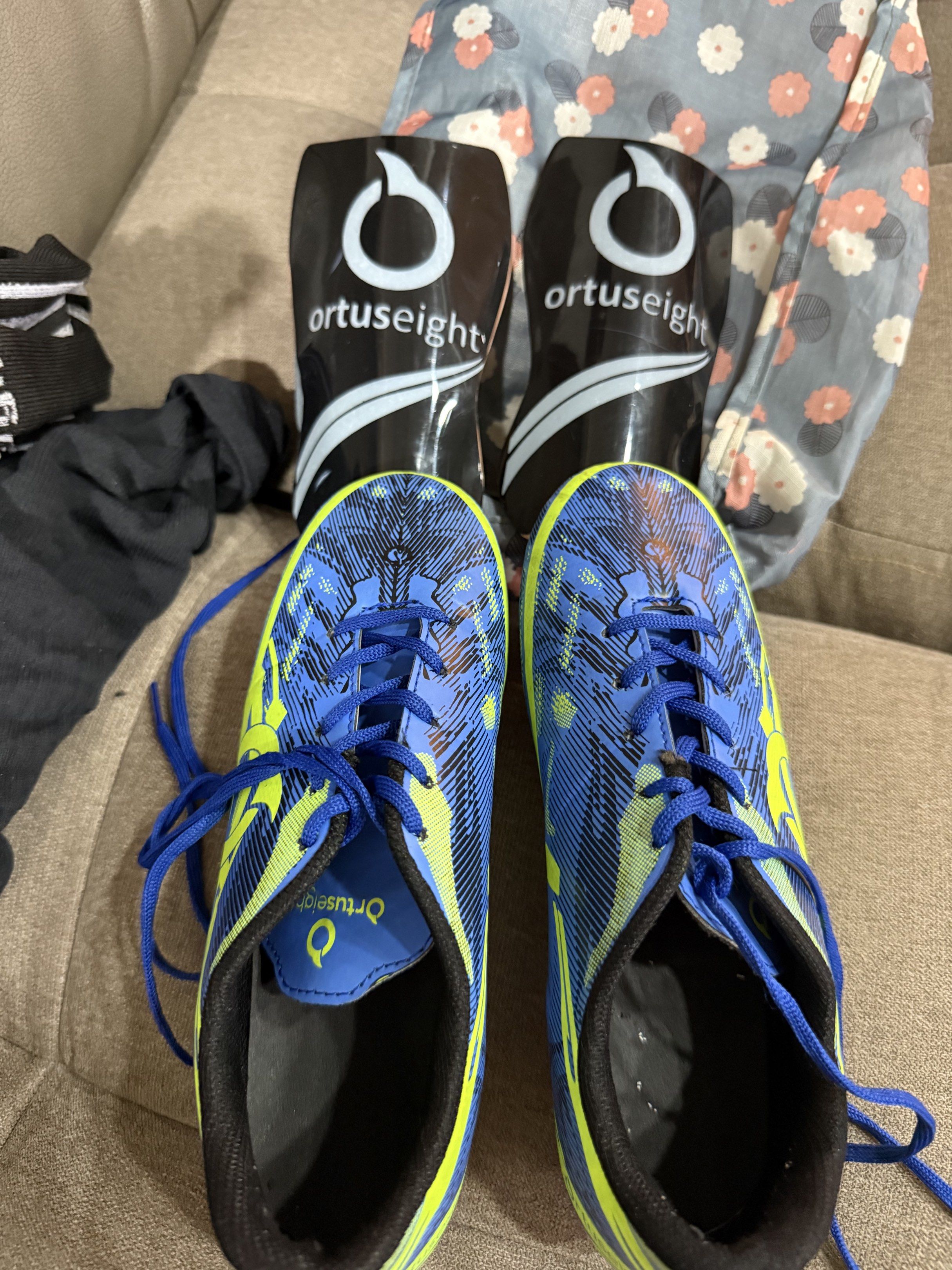 Ortuseight Soccer Cleats and Jersey Set (Category: Racket and Ball Sports) located in Manila. Submitted by daveeh (Listing ID 1418474195, Image 1). Description: - Ortuseight soccer set - Includes: - Blue and yellow cleats with blue laces and sole size 24 - Black and blue jersey with Ortuseight logo - Black shin guards with Ortuseight logo.