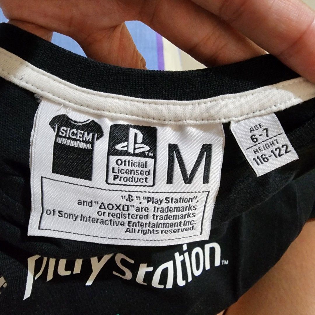 PlayStation Official Licensed T-shirt - Size M (Category: Babies & Kids Fashion) located in Valenzuela. Submitted by teachermommyph (Listing ID 1418419521, Image 2). Description: - Black PlayStation t-shirt - Size: M, 6-7 yrs olsd - Official licensed product - Features PlayStation logo and button symbols with colorful splatter design - Suitable for ages 6-7 (height: 116-122 cm) - Brand: SICEM INTERNATIONAL.