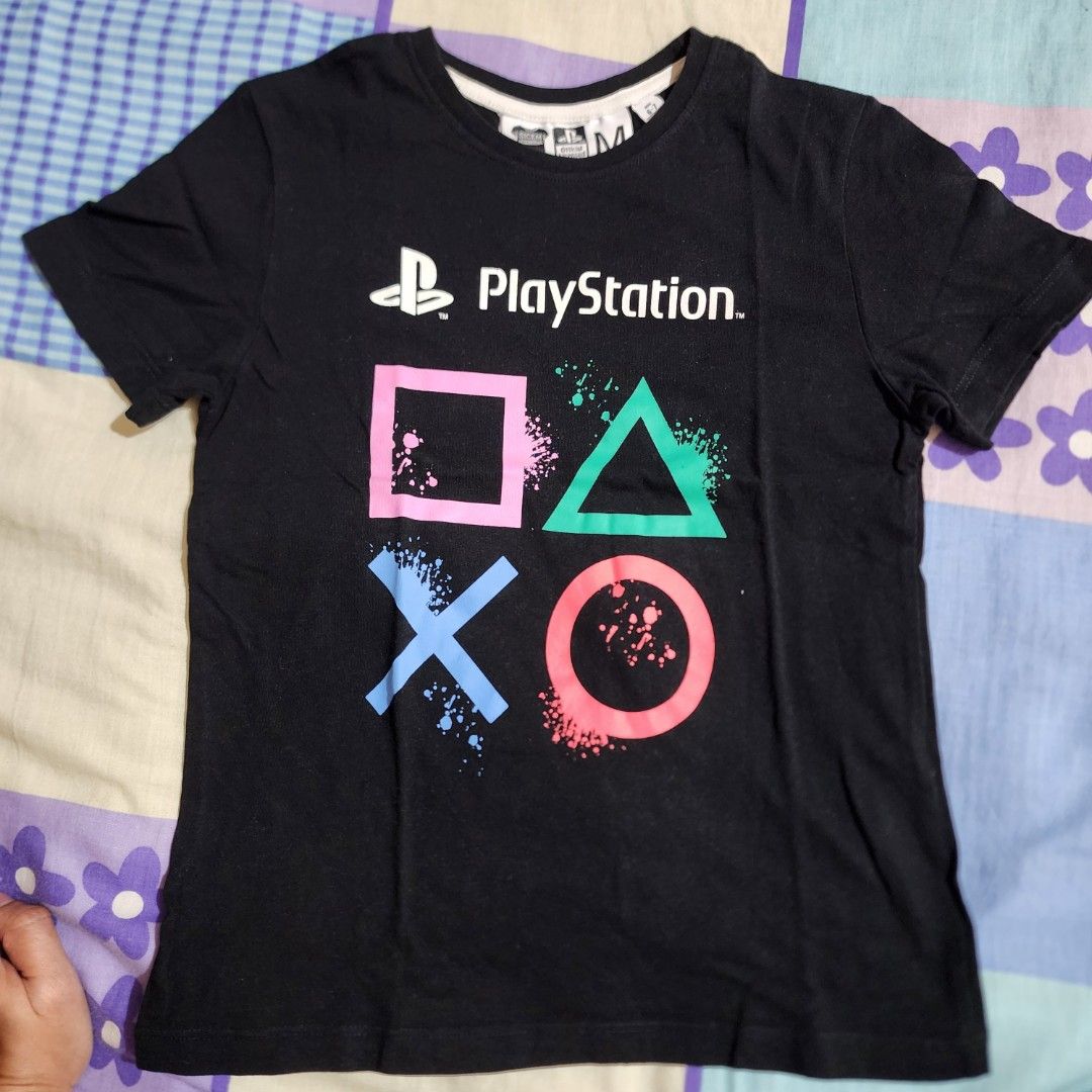 PlayStation Official Licensed T-shirt - Size M (Category: Babies & Kids Fashion) located in Valenzuela. Submitted by teachermommyph (Listing ID 1418419521, Image 1). Description: - Black PlayStation t-shirt - Size: M, 6-7 yrs olsd - Official licensed product - Features PlayStation logo and button symbols with colorful splatter design - Suitable for ages 6-7 (height: 116-122 cm) - Brand: SICEM INTERNATIONAL.