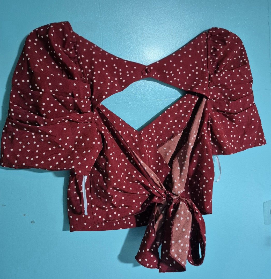 Polka Dot Wrap Top (Category: Blouses) located in Taguig. Submitted by perfect_restyle (Listing ID 1418560135, Image 2). Description: - Burgundy wrap top with white polka dots - Unique keyhole back design - Stylish puff sleeves - Tie closure at the back - Made of lightweight fabric - Ideal for warmer weather - Dress it up or down!.