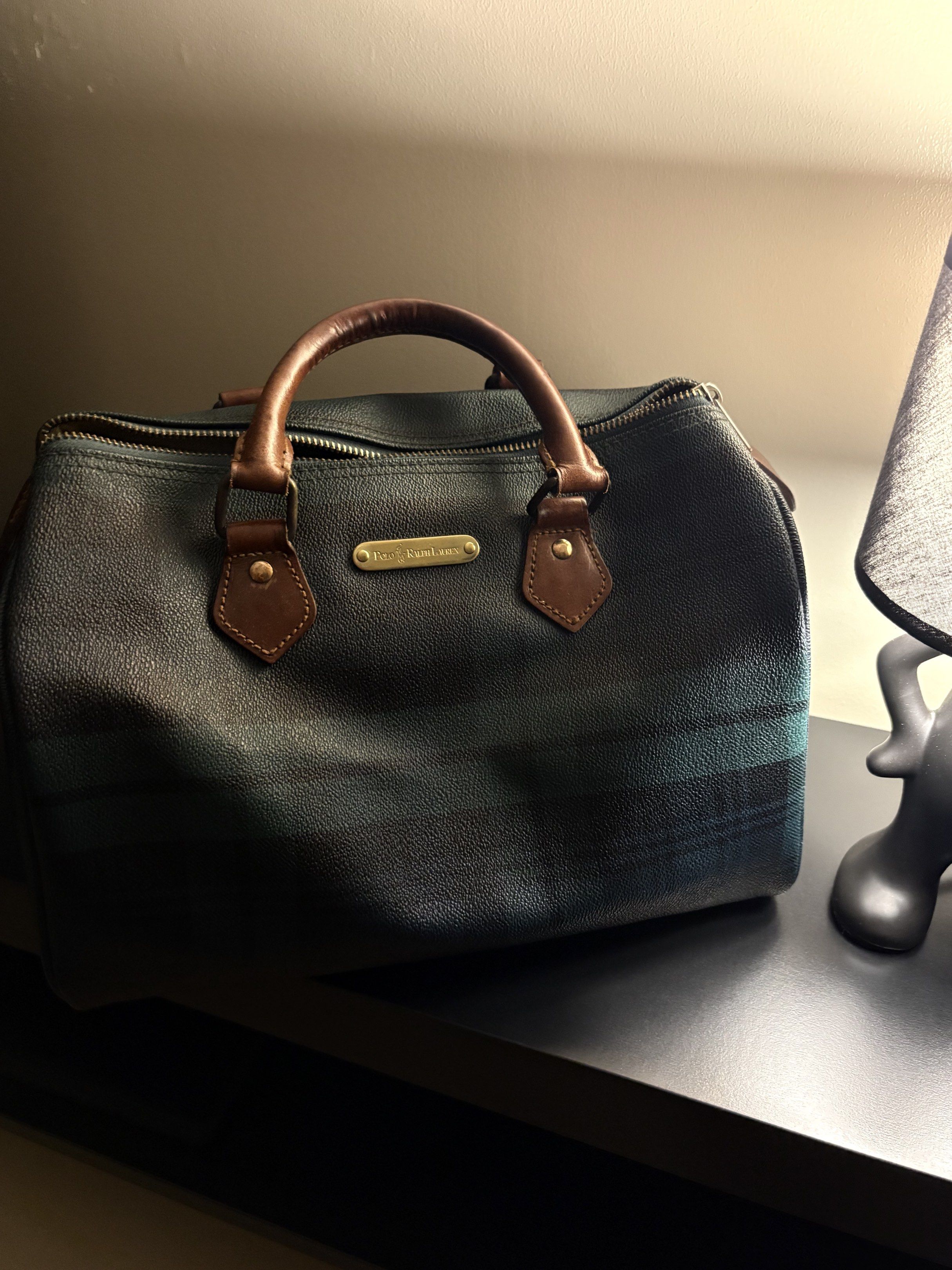 Authentic RL boston bag (Category: Luxury Bags & Wallets) located in Pasay City. Submitted by r867737 (Listing ID 1418519087, Image 1). Description: - Classic plaid design in dark green and blue - Brown leather handles and accents - Includes brand name plaque - Secure zippered closure - Medium size Excellent condition for a vintage bag no rubs on corners on stains inside .