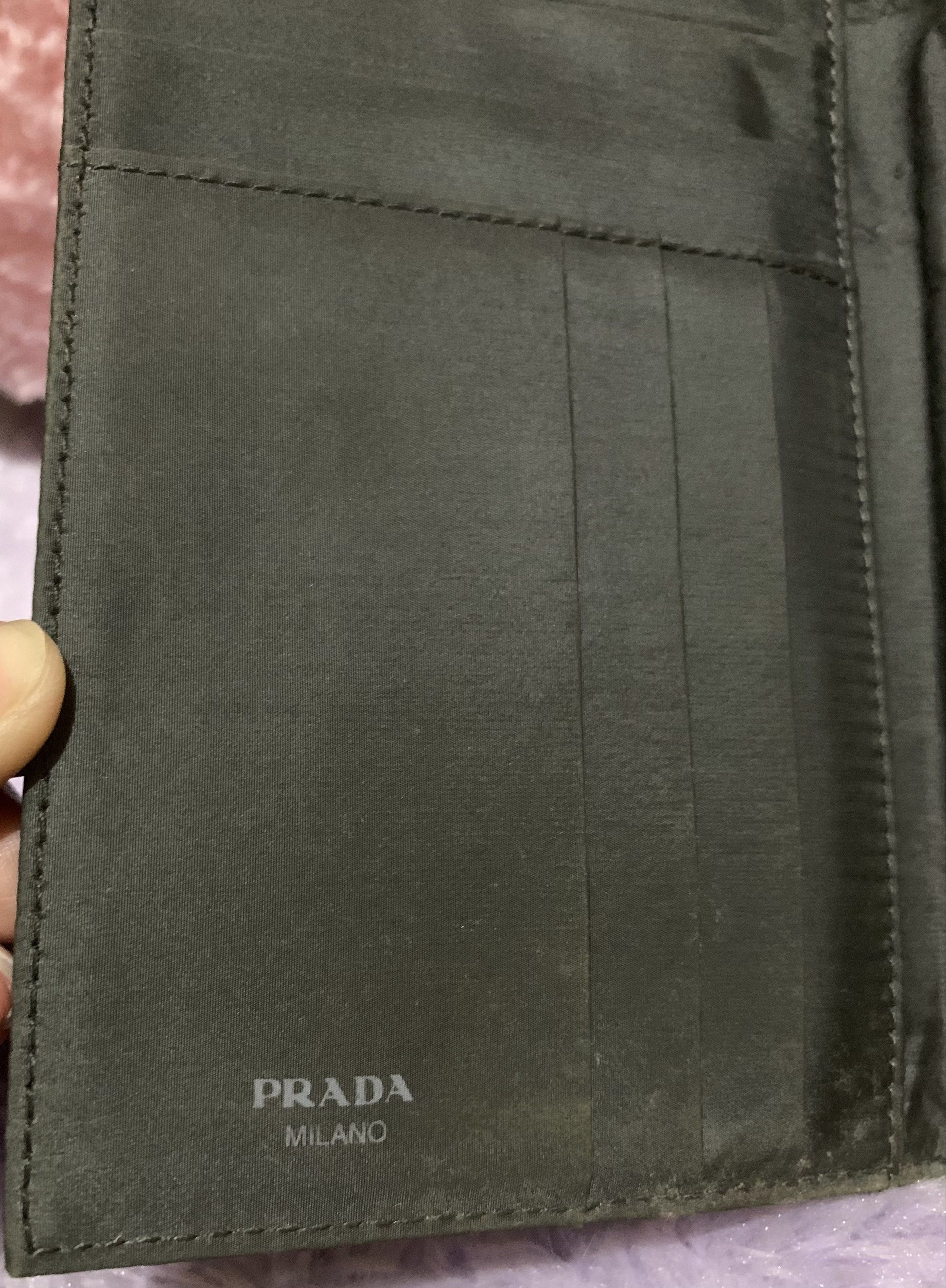 Prada Patterned Wallet (Category: Luxury Bags & Wallets) located in Quezon City. Submitted by ncjnc (Listing ID 1418553768, Image 2). Description: - Authentic Prada wallet - Patterned exterior - Multiple card slots - Bill compartment - Black interior with Prada Milano logo - Snap closure - Flap with Prada logo - Shows some wear.