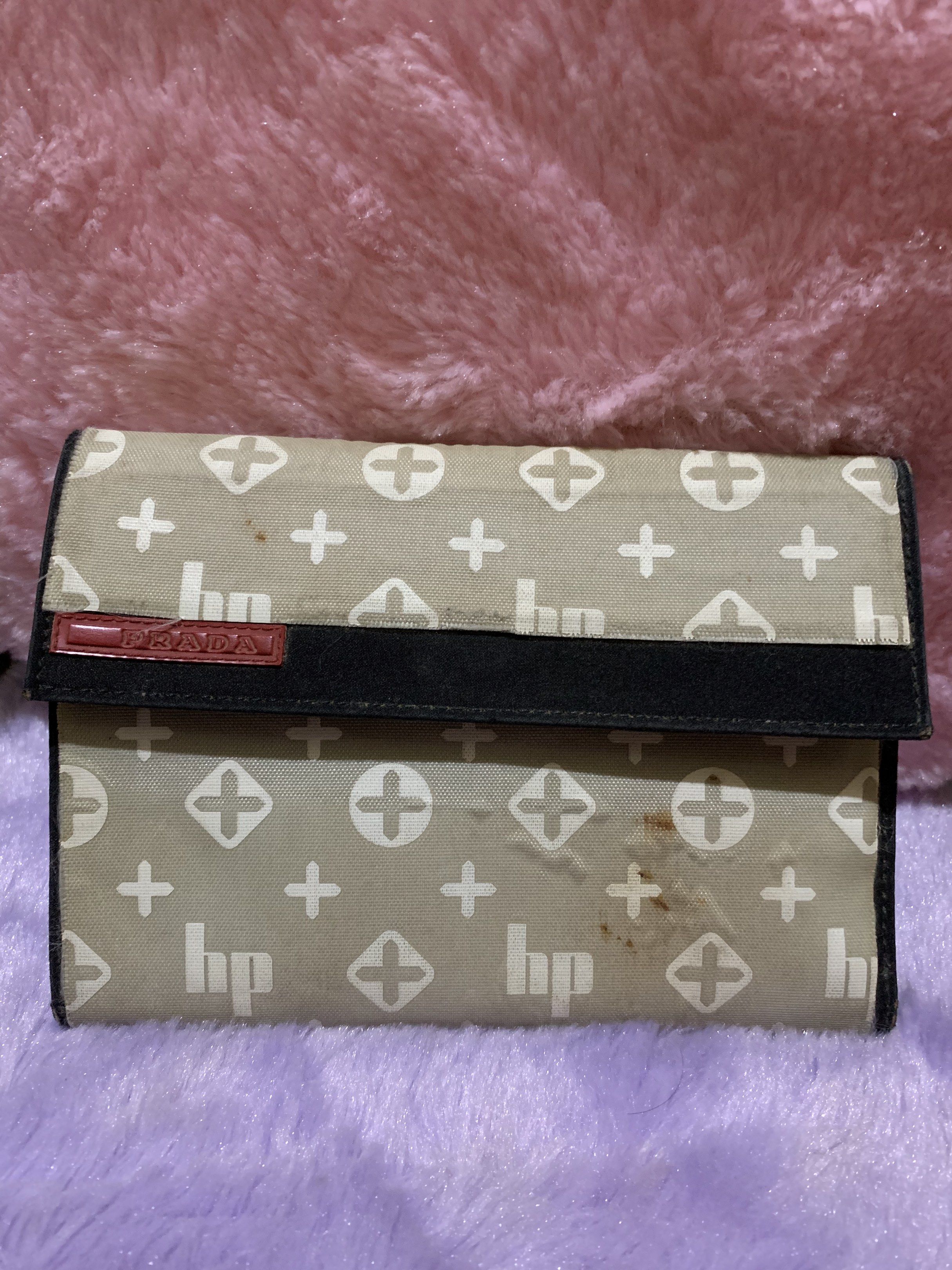 Prada Patterned Wallet (Category: Luxury Bags & Wallets) located in Quezon City. Submitted by ncjnc (Listing ID 1418553768, Image 1). Description: - Authentic Prada wallet - Patterned exterior - Multiple card slots - Bill compartment - Black interior with Prada Milano logo - Snap closure - Flap with Prada logo - Shows some wear.