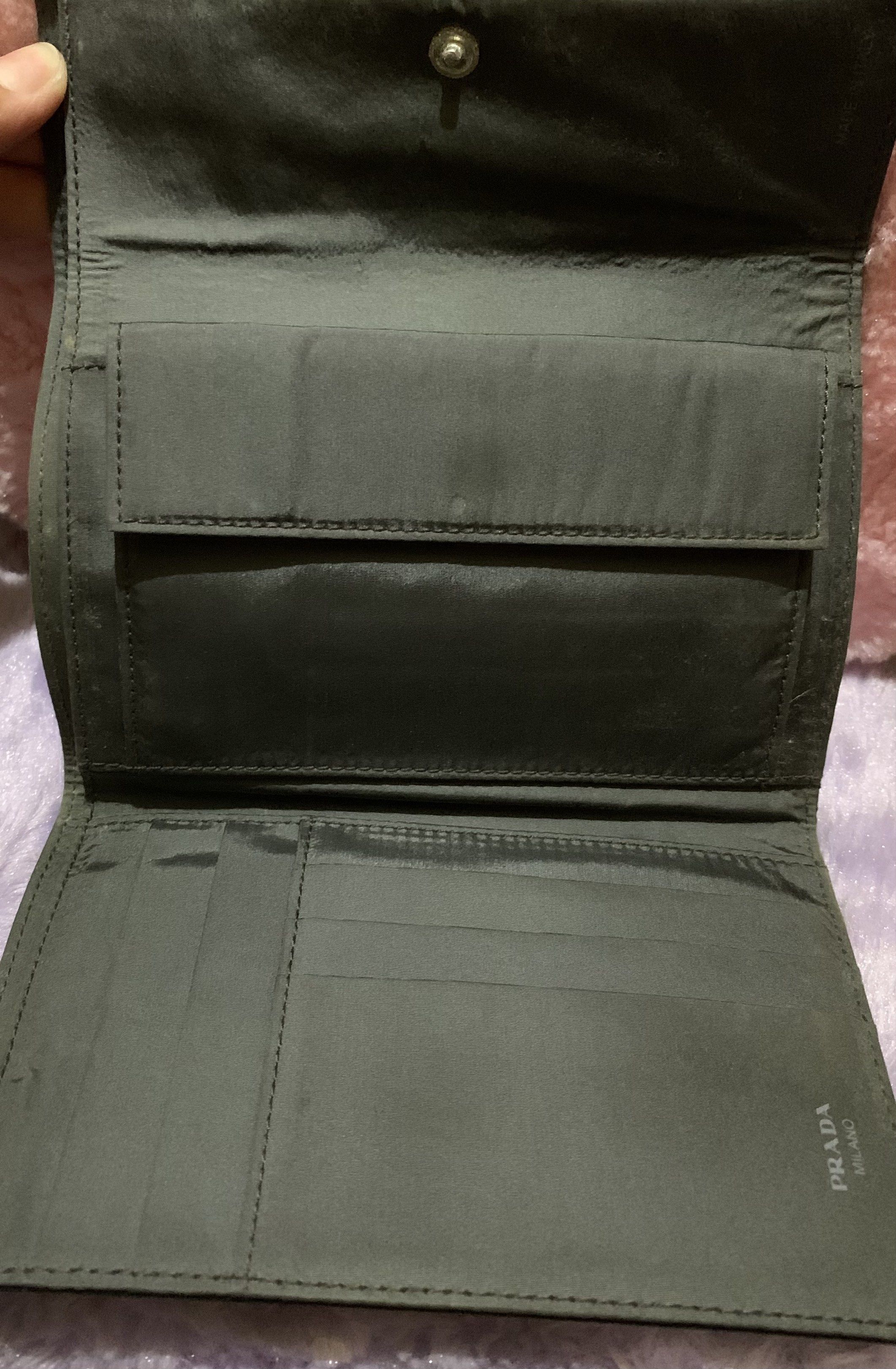Prada Patterned Wallet (Category: Luxury Bags & Wallets) located in Quezon City. Submitted by ncjnc (Listing ID 1418553768, Image 3). Description: - Authentic Prada wallet - Patterned exterior - Multiple card slots - Bill compartment - Black interior with Prada Milano logo - Snap closure - Flap with Prada logo - Shows some wear.