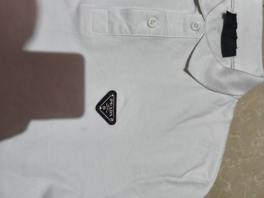 Prada White Polo Shirt (Category: Luxury Apparel) located in Manila. Submitted by rms.thrift (Listing ID 1418528582, Image 3). Description: prada polo shirt complete all tags no issue 27x22.