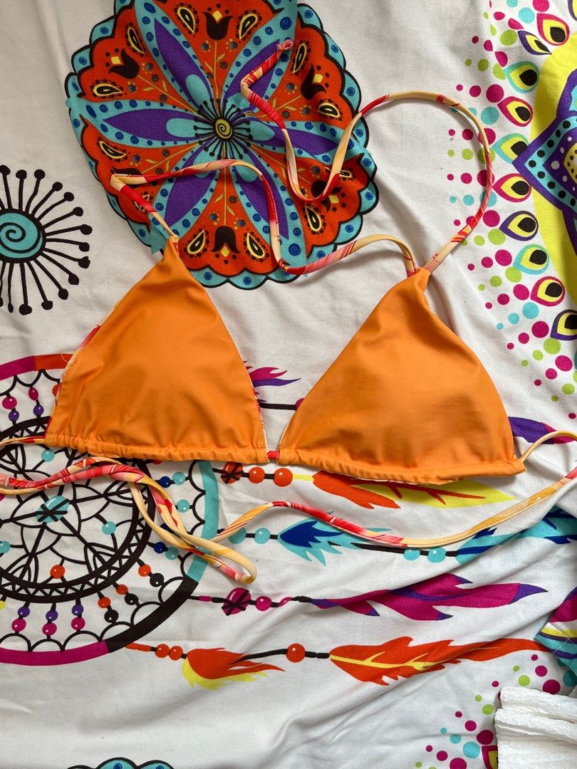 Reversible Orange Floral Bikini Top (Category: Bikinis & Swimsuits) located in Paranaque City. Submitted by rieclutter (Listing ID 1418433241, Image 2). Description: - never used, not my size - Reversible bikini top - Features a vibrant floral print and solid orange color - Adjustable straps for a comfortable fit - Classic triangle shape - Ideal for beach or pool days.