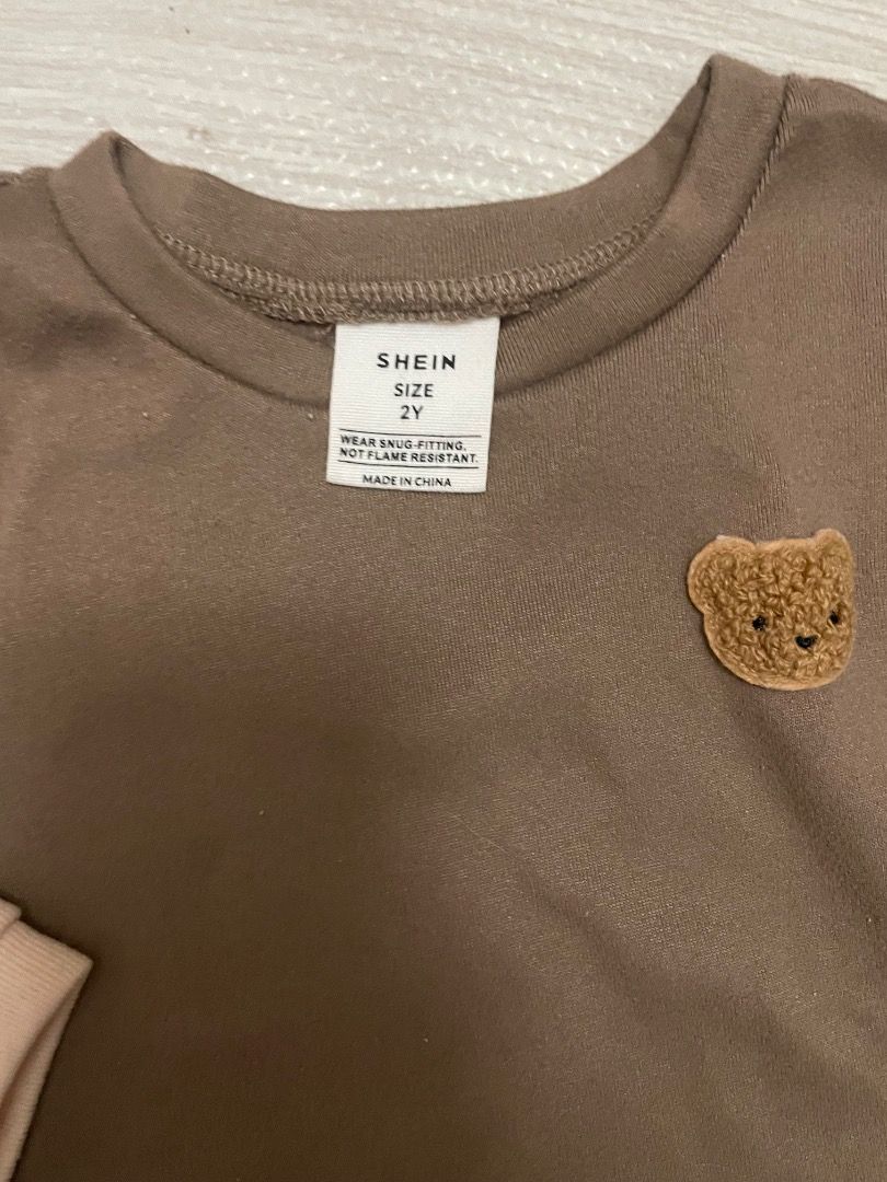 Shein 2Y Bear Applique Top and Pants Set (Category: Babies & Kids Fashion) located in Casiguran. Submitted by roseromano (Listing ID 1418430503, Image 2). Description: - Shein 2Y clothing set - Includes short-sleeved top with bear applique and matching pants - Available in beige and brown - Snug fit design - Made in China - Not flame resistant Take all.