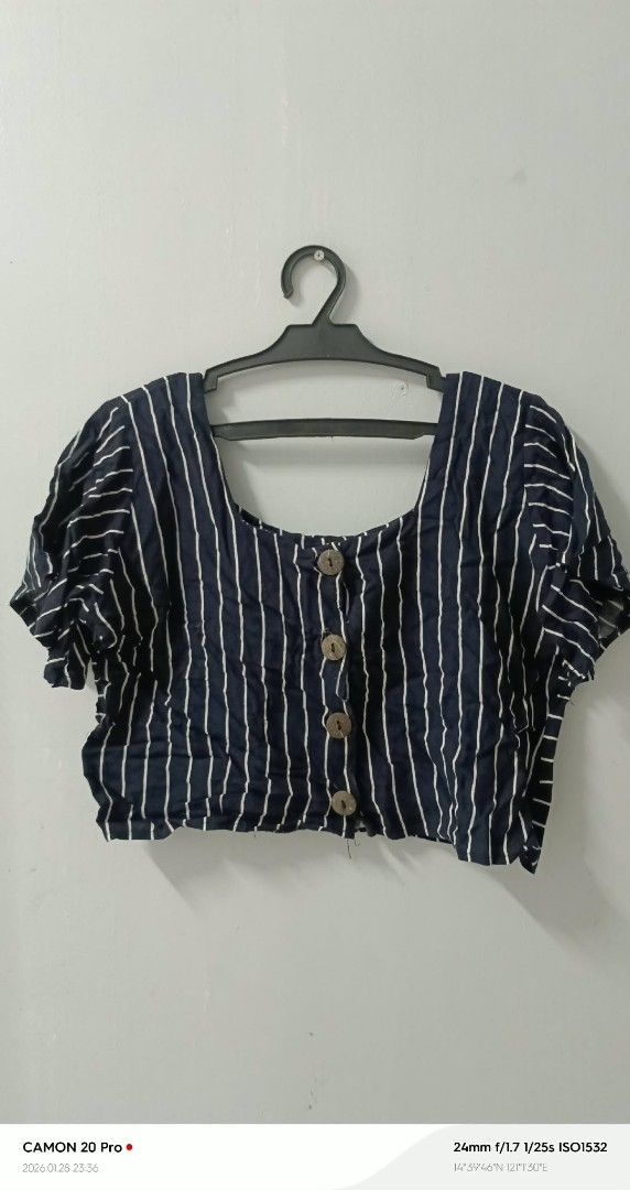 Striped Crop Top (Category: Sleeveless) located in Quezon City. Submitted by sheila0721 (Listing ID 1418464053, Image 2). Description: - Navy blue and white striped crop top - Short sleeves - Square neckline - Button-down front - Lightweight fabric - Ideal for warm weather - Great with high-waisted bottoms fit to S-M.