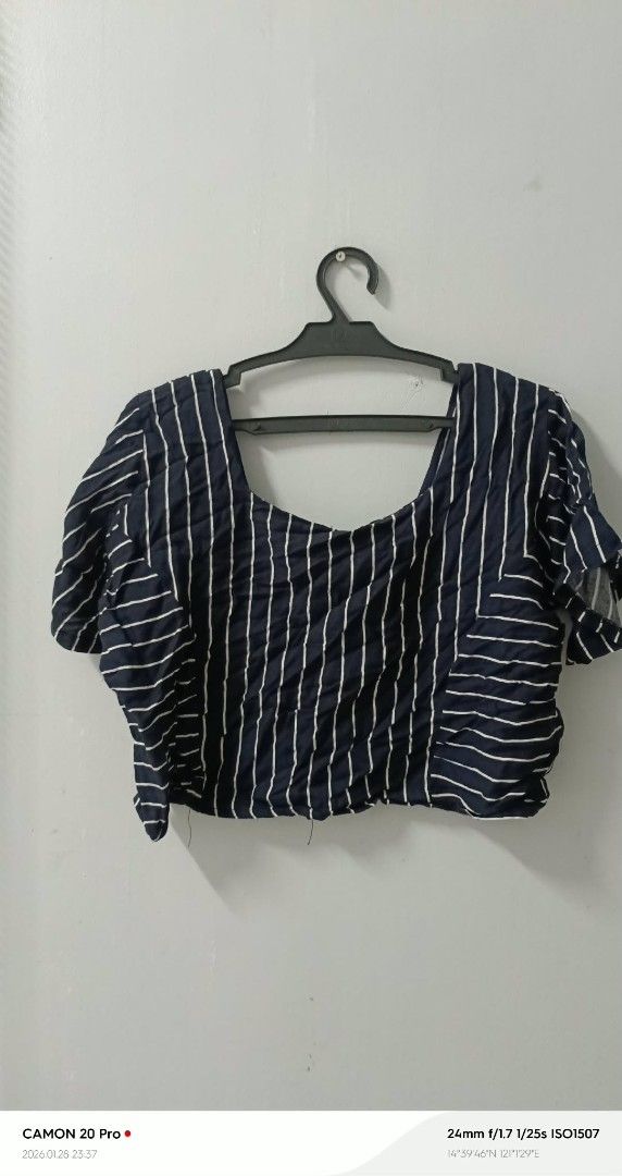 Striped Crop Top (Category: Sleeveless) located in Quezon City. Submitted by sheila0721 (Listing ID 1418464053, Image 1). Description: - Navy blue and white striped crop top - Short sleeves - Square neckline - Button-down front - Lightweight fabric - Ideal for warm weather - Great with high-waisted bottoms fit to S-M.