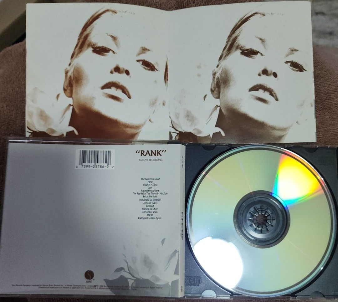 The Smiths - Rank (Category: CDs & DVDs) located in Cebu City. Submitted by g_roshamboo (Listing ID 1418575360, Image 3). Description: Smiths "Rank" CD. Includes the CD and the original booklet. The CD features tracks like "The Queen Is Dead", "Panic", and "What She Said". The album cover art is visible. The CD case is included..